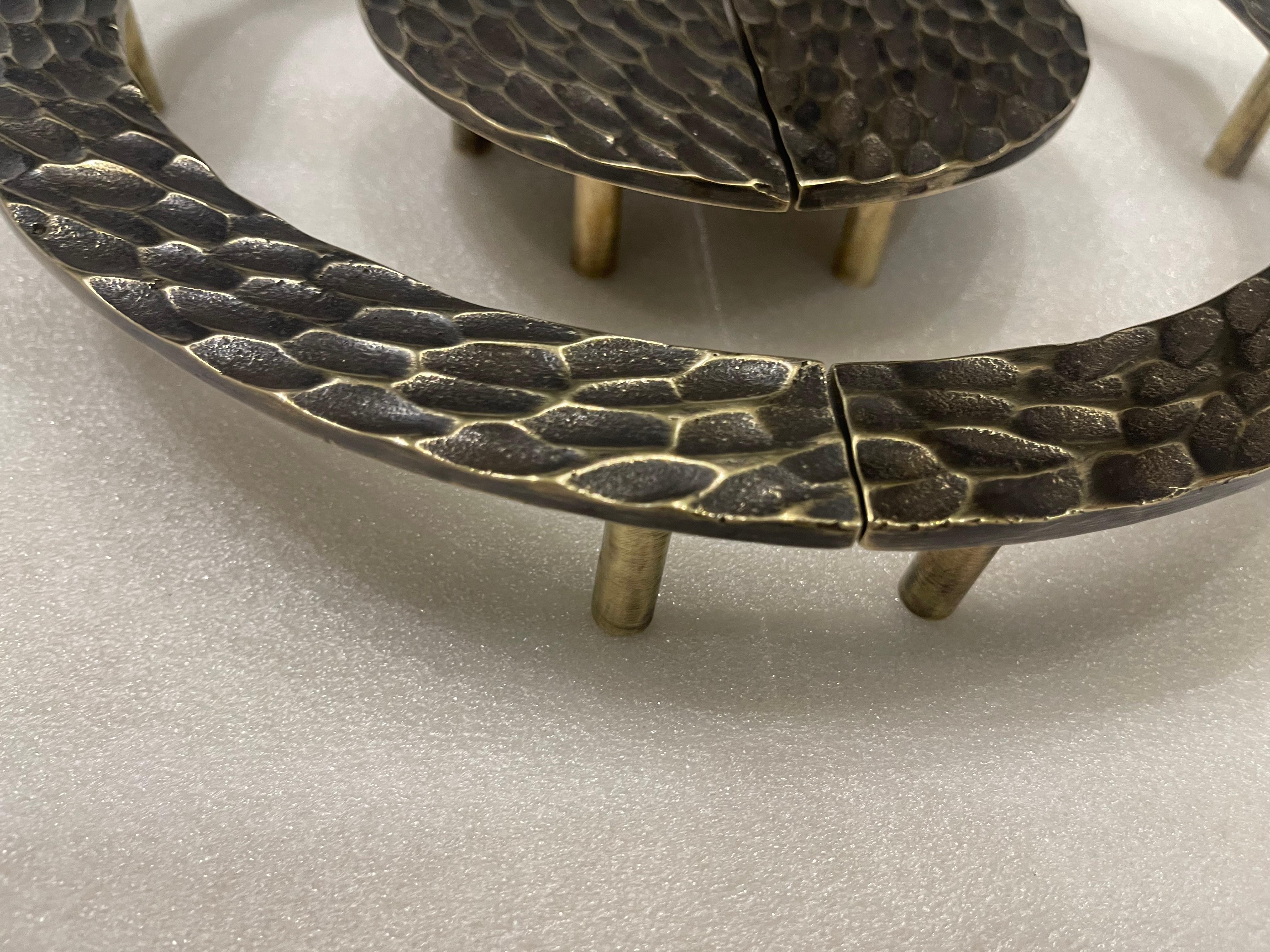 Il set di tiranti per porte RiZO Hive in ottone presenta un design superficiale artigianale che ricorda un motivo a nido d'ape, conferendogli un aspetto unico e tattile. L'ottone ricco di materiali offre una calda tonalità dorata invecchiata e