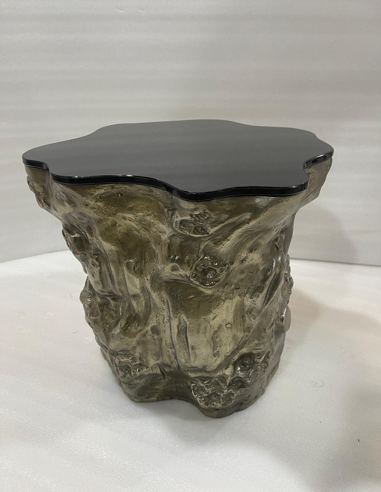 The Strom series is a nature inspired furniture design with more than an organically sculpted form to present. The base illustrates a charismatic part of a tree trunk in molten patinated brass finish and the fine metallic glass top brings a