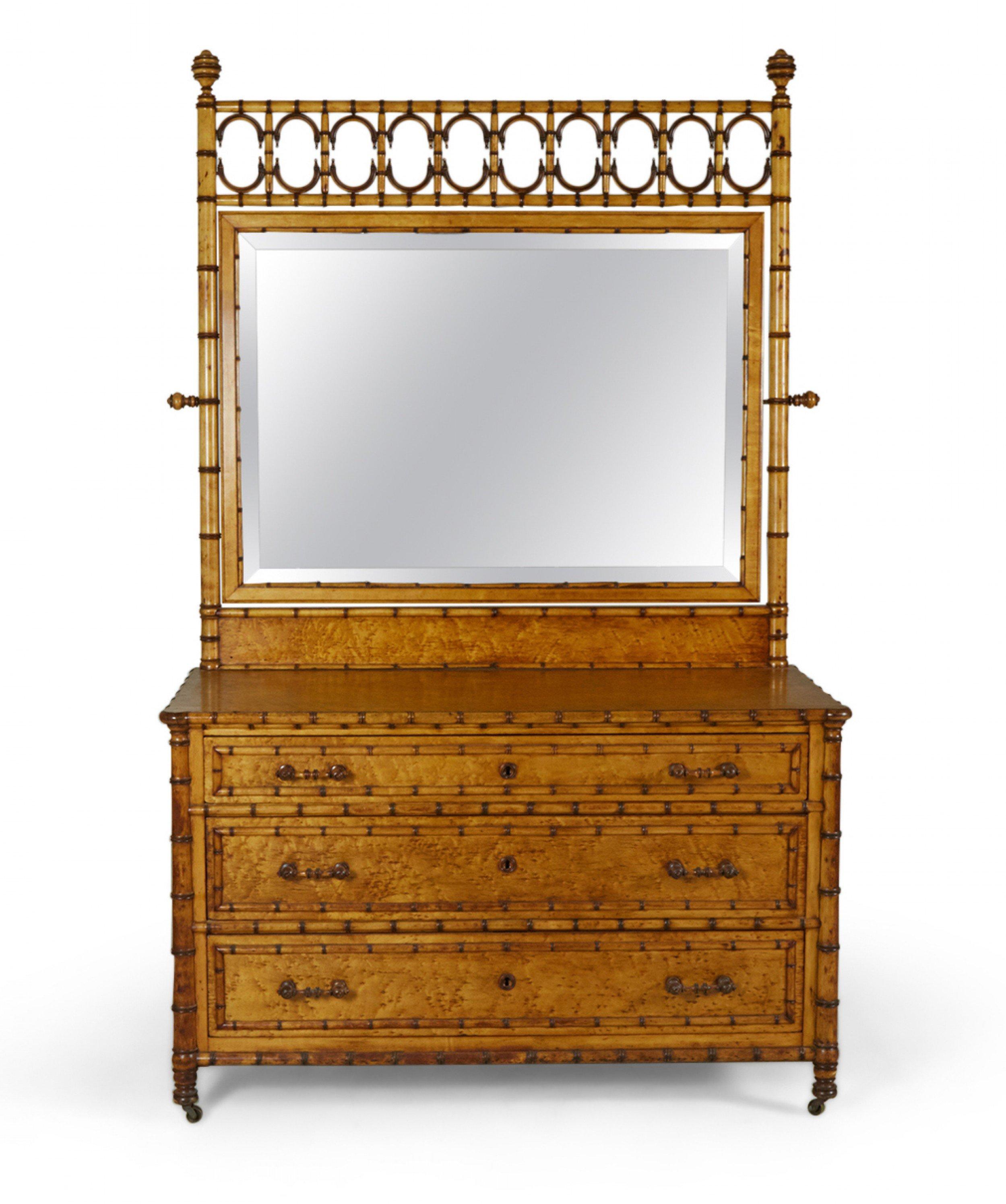 American Victorian Aesthetic Movement amber stained birds eye maple faux bamboo dresser with three drawers beneath a rectangular pivoting mirror mounted in a decorative faux bamboo frame with ball finial tops. (R.J. HORNER) (no keys).
 