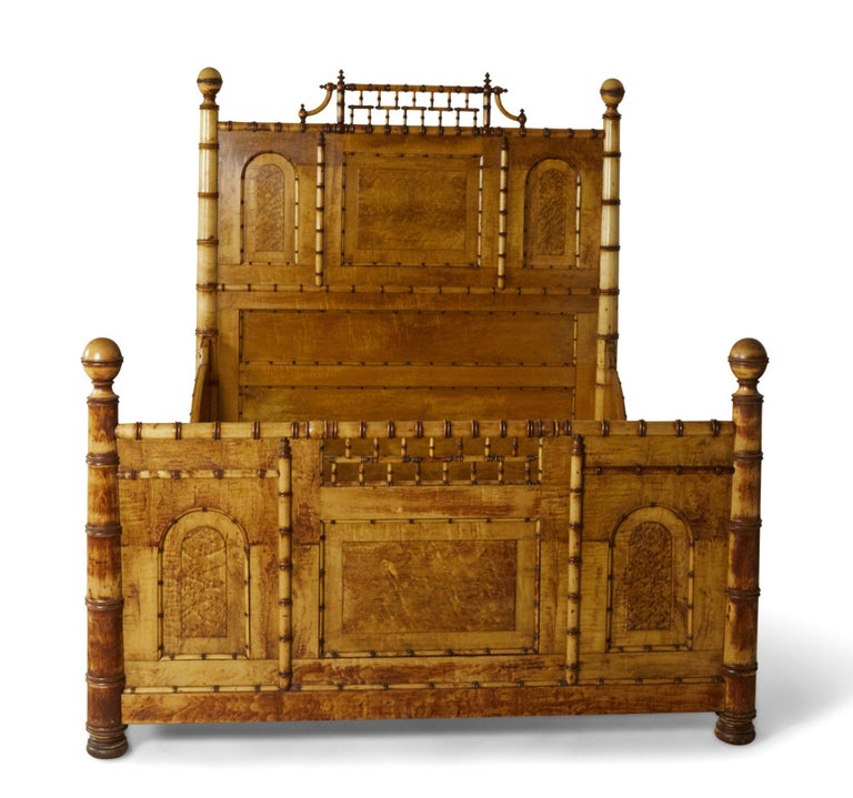 American Victorian Aesthetic Movement carved birdseye maple faux bamboo full-size bed with a spindled crest, paneled head and foot-boards, and ball finials, and bracketed rails. (R.J. HORNER).