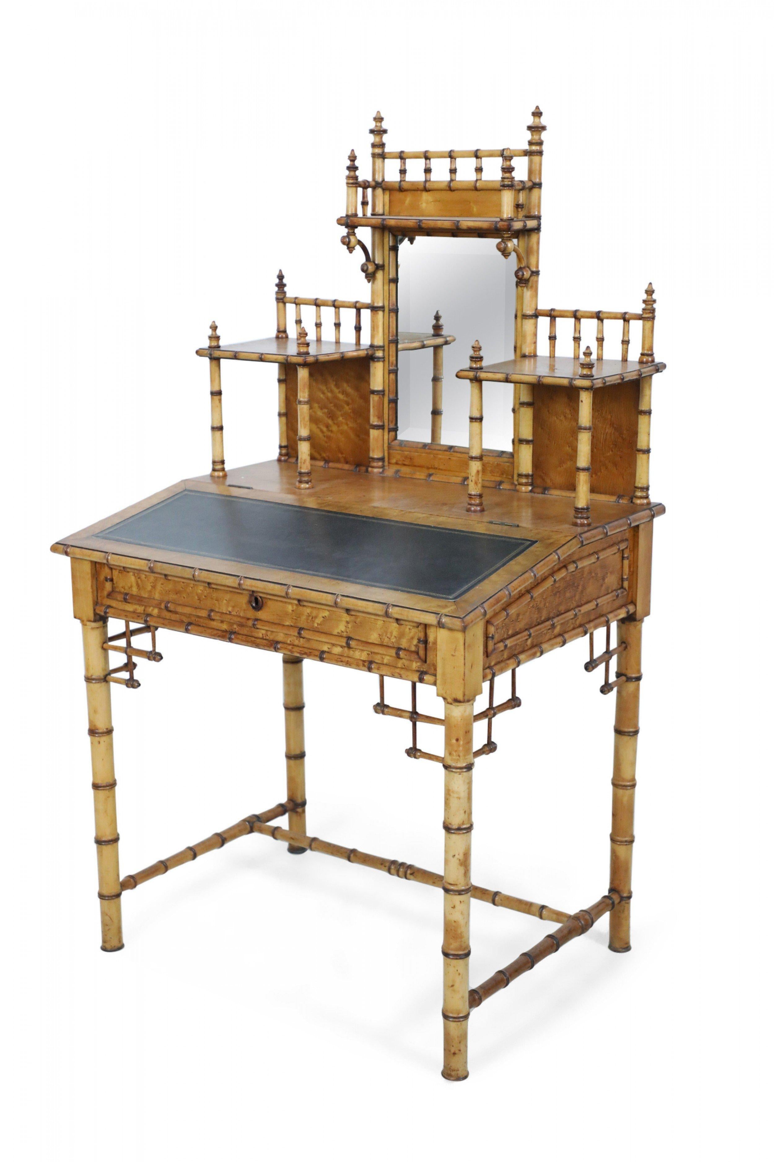 American Victorian Aesthetic Movement amber stained birdseye maple faux bamboo writing desk having an upper shelf with a central mirror and a tilted black leather writing surface which opens to reveal an interior compartment. (R.J. HORNER).
 