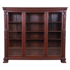 R.J. Horner Antique Renaissance Revival Carved Oak Glass Front Triple Bookcase