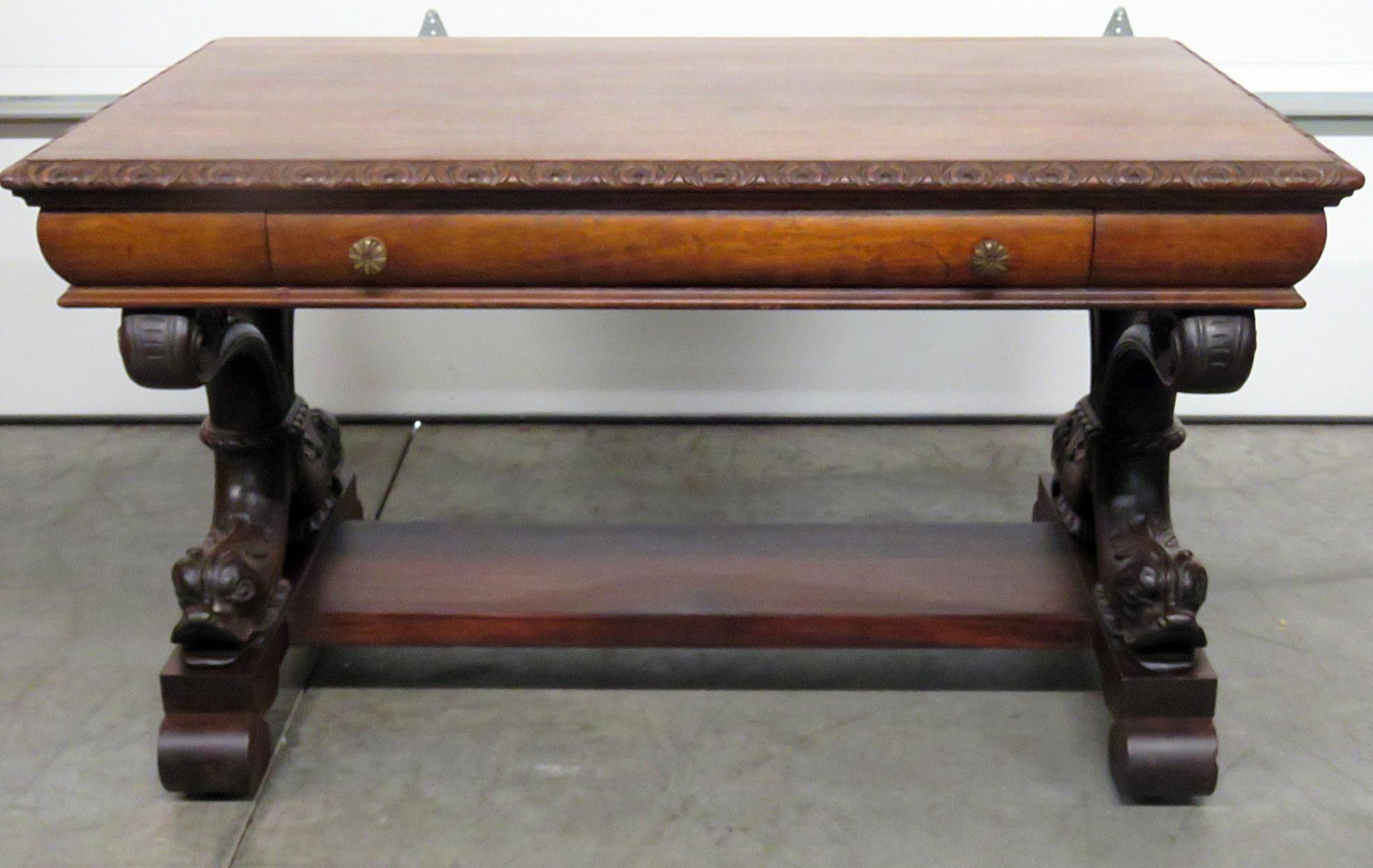 This is a fine RJ Horner style desk. It may even be RJ Horner but is not marked. The desk features two mythical 