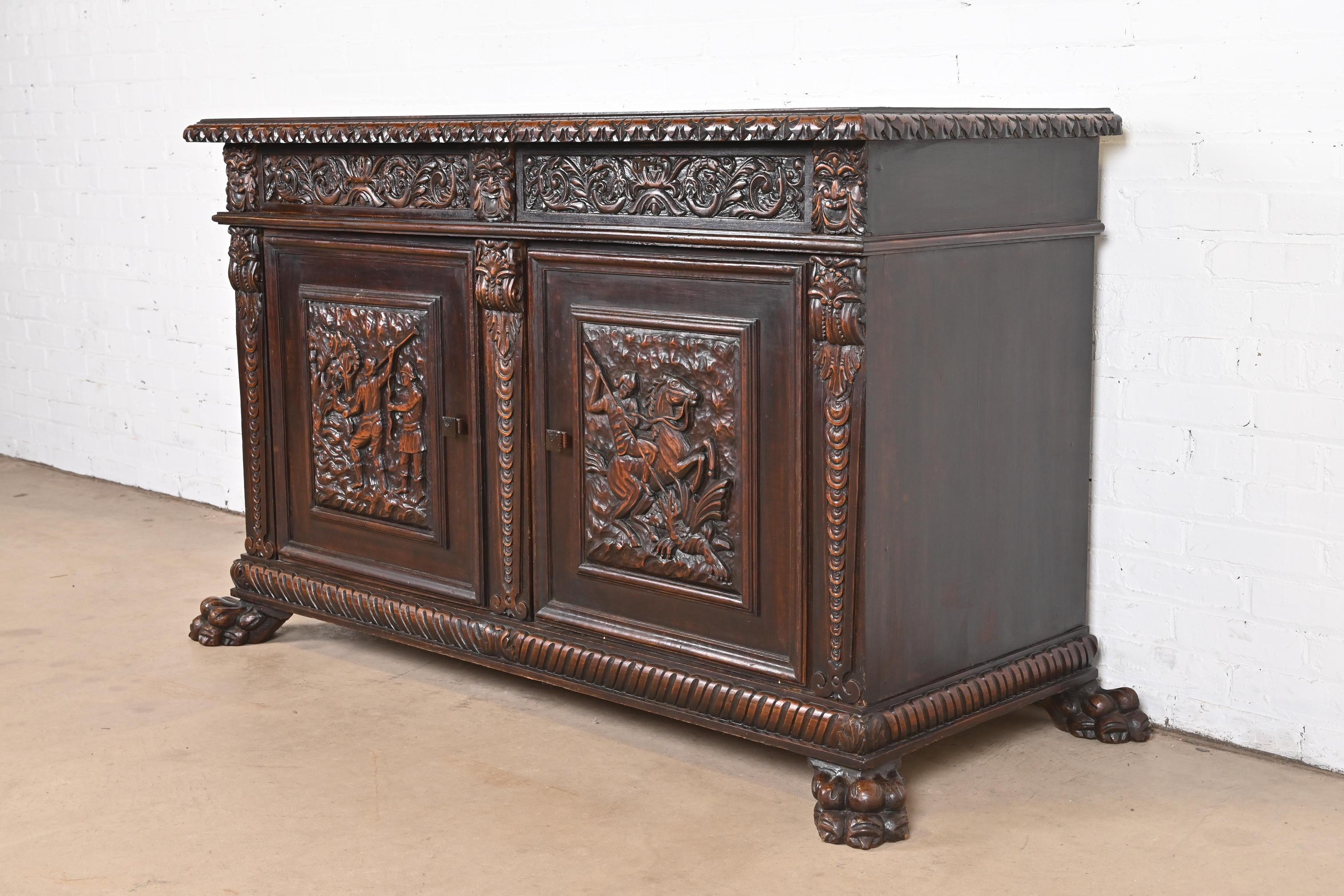 An exceptional Victorian or Renaissance Revival sideboard, credenza, or bar cabinet

In the manner of R.J. Horner 

Romania, Circa 1890s

Walnut, with carved faces and hunting scenes, and paw feet.

Measures: 63