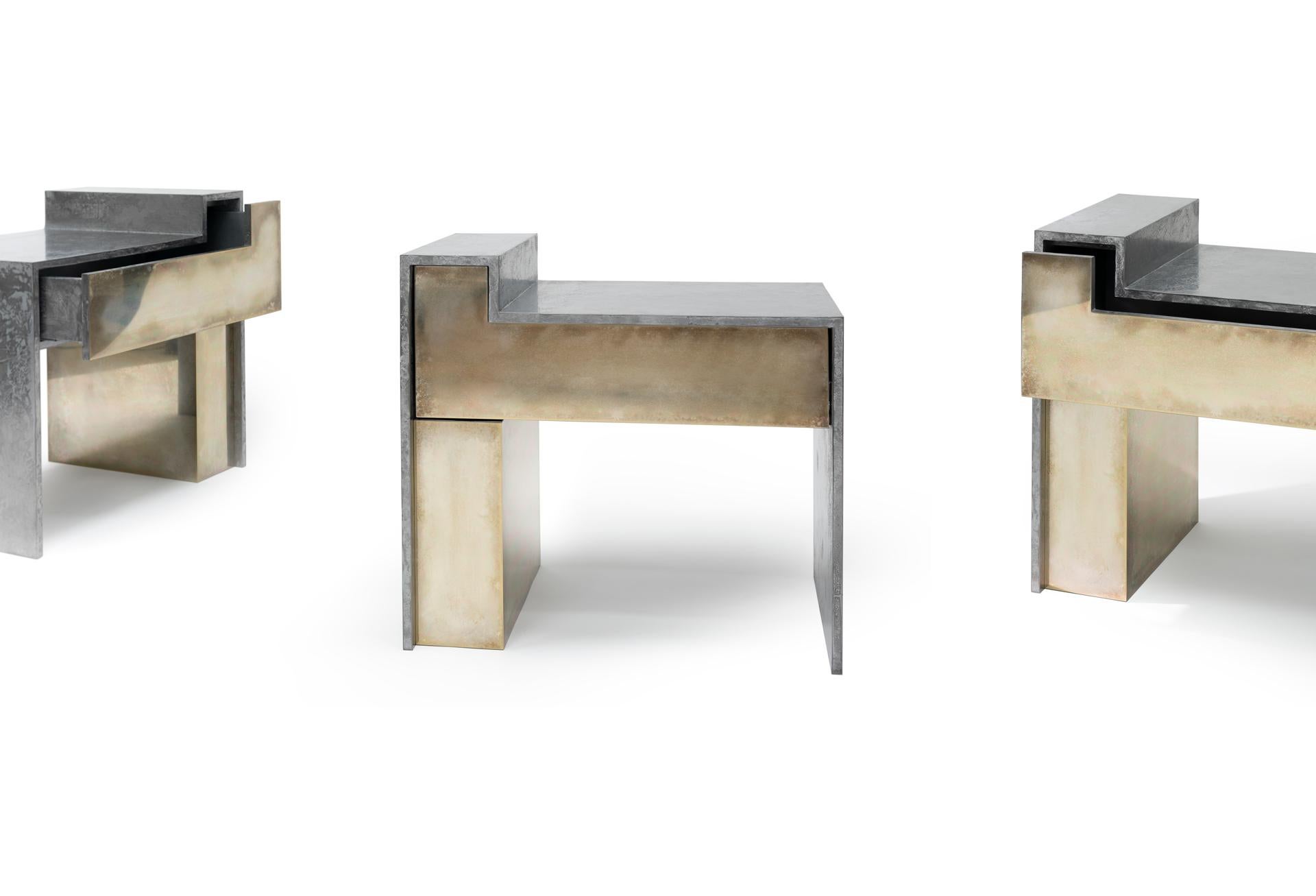 The bespoke RLB BST bedside table is a nightstand that can be produced in a variety of brass and liquid metal based finishes. As pictured, these tables feature hand silvered brass façades with a liquid gun metal finished structure. A single drawer