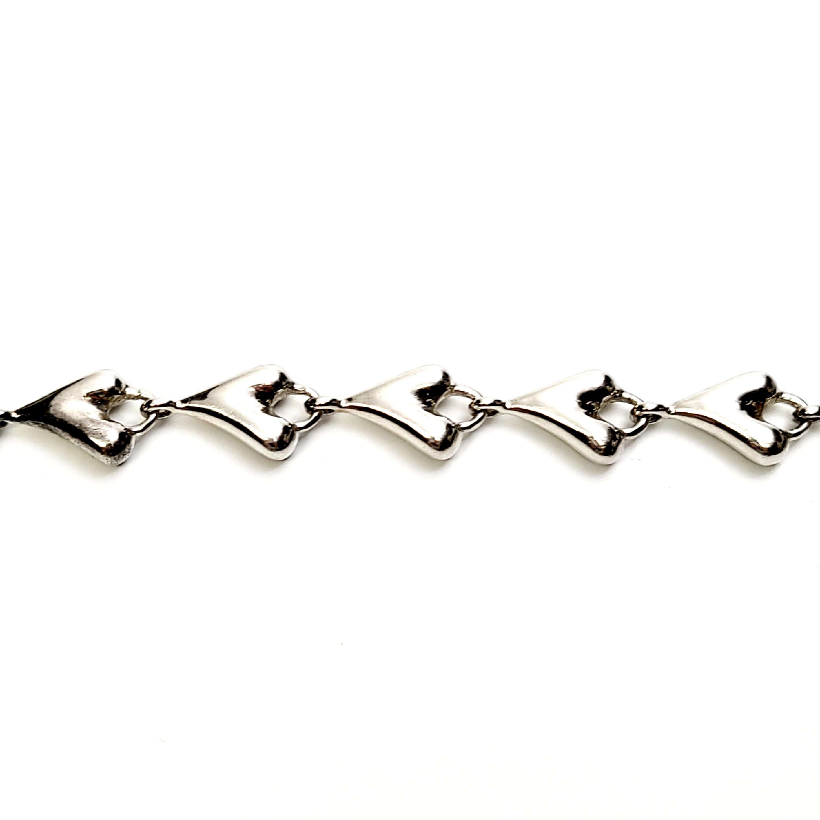 Sterling silver heart bracelet by designer Robert Lee Morris.

This modernist designer piece features elongated heart links.

Measures approx 7 1/2