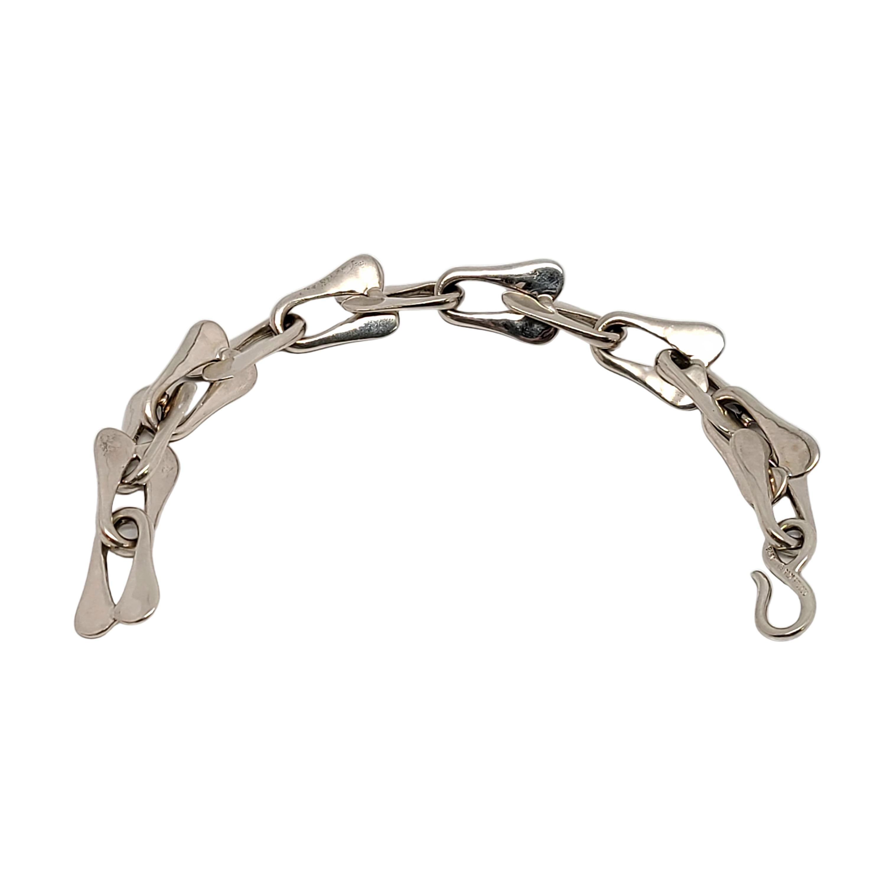 Sterling silver modernist link bracelet by designer Robert Lee Morris.

This modernist designer piece features elongated flat U-shaped links.

Measures approx 9