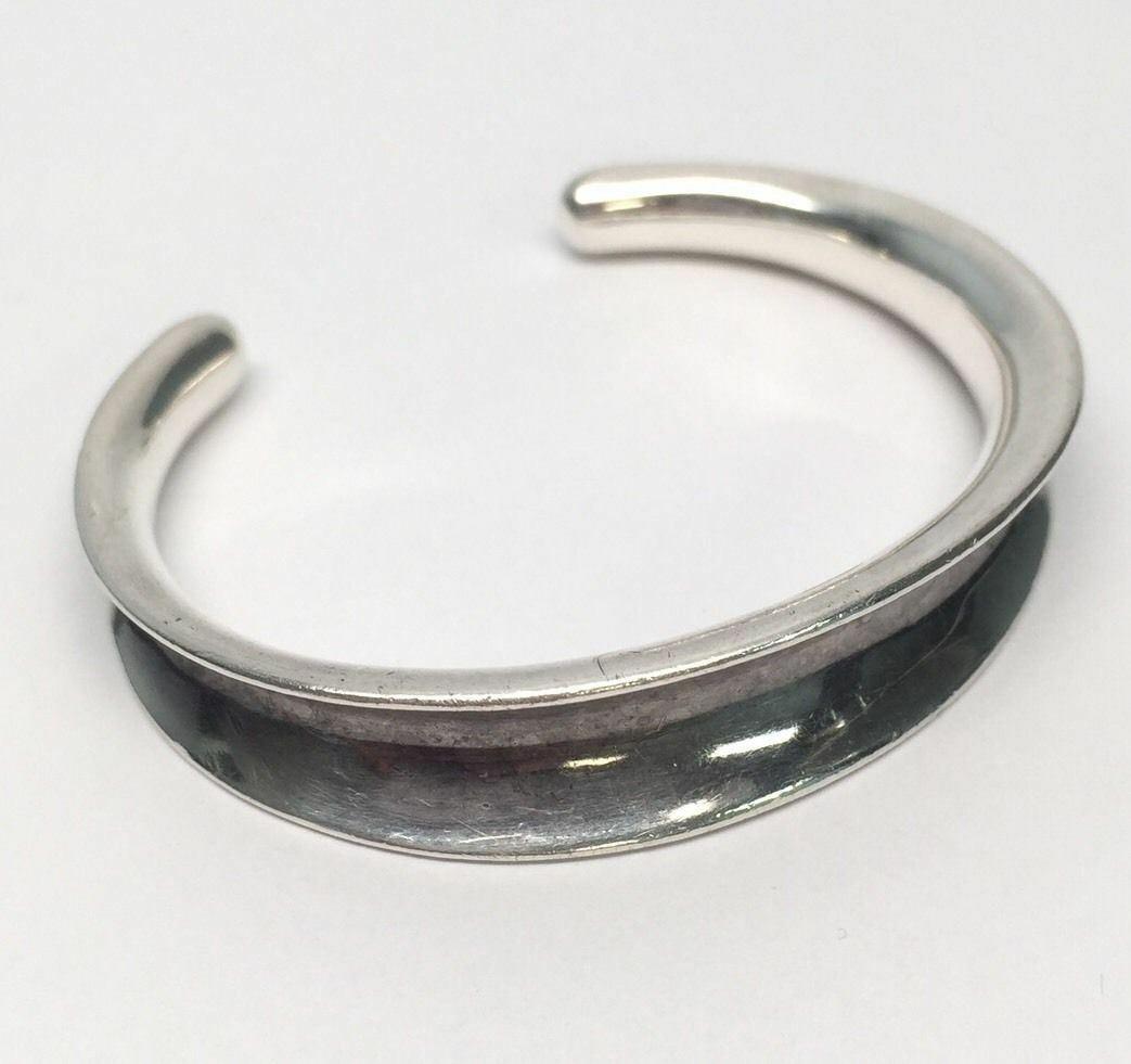 RLM (Robert Lee Morris) Studio sterling silver oxidized concave cuff bracelet.

Marking: RLM STUDIO .925.

Measures approx. 5 1/4