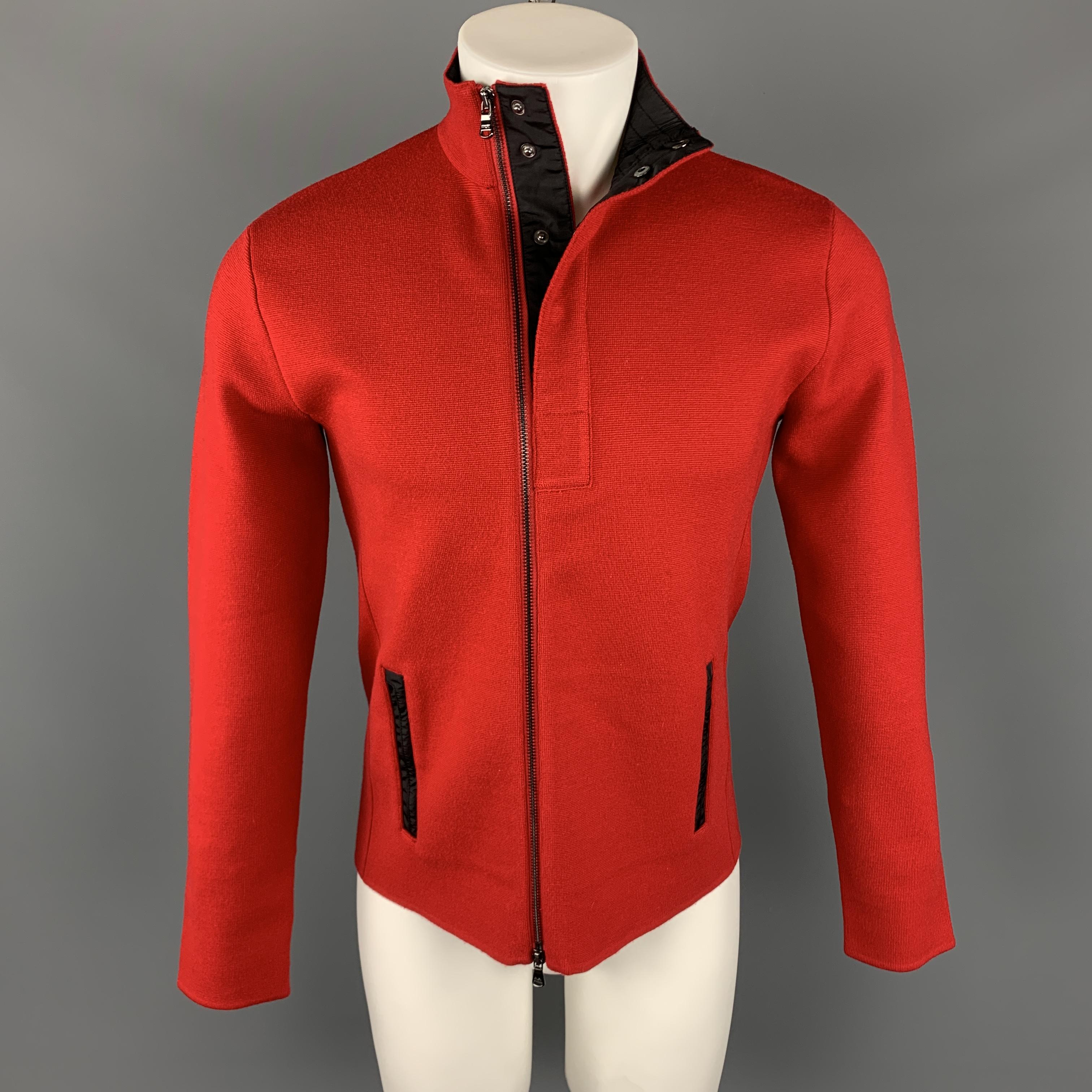 RLX by RALPH LAUREN Jacket comes in a red tone in a solid wool blend material, with a high collar, zip and snaps at closure, zip pockets, and elbow patches. Minor wear, with a light mark at back.
 
Very Good Pre-Owned Condition.
Marked: S
