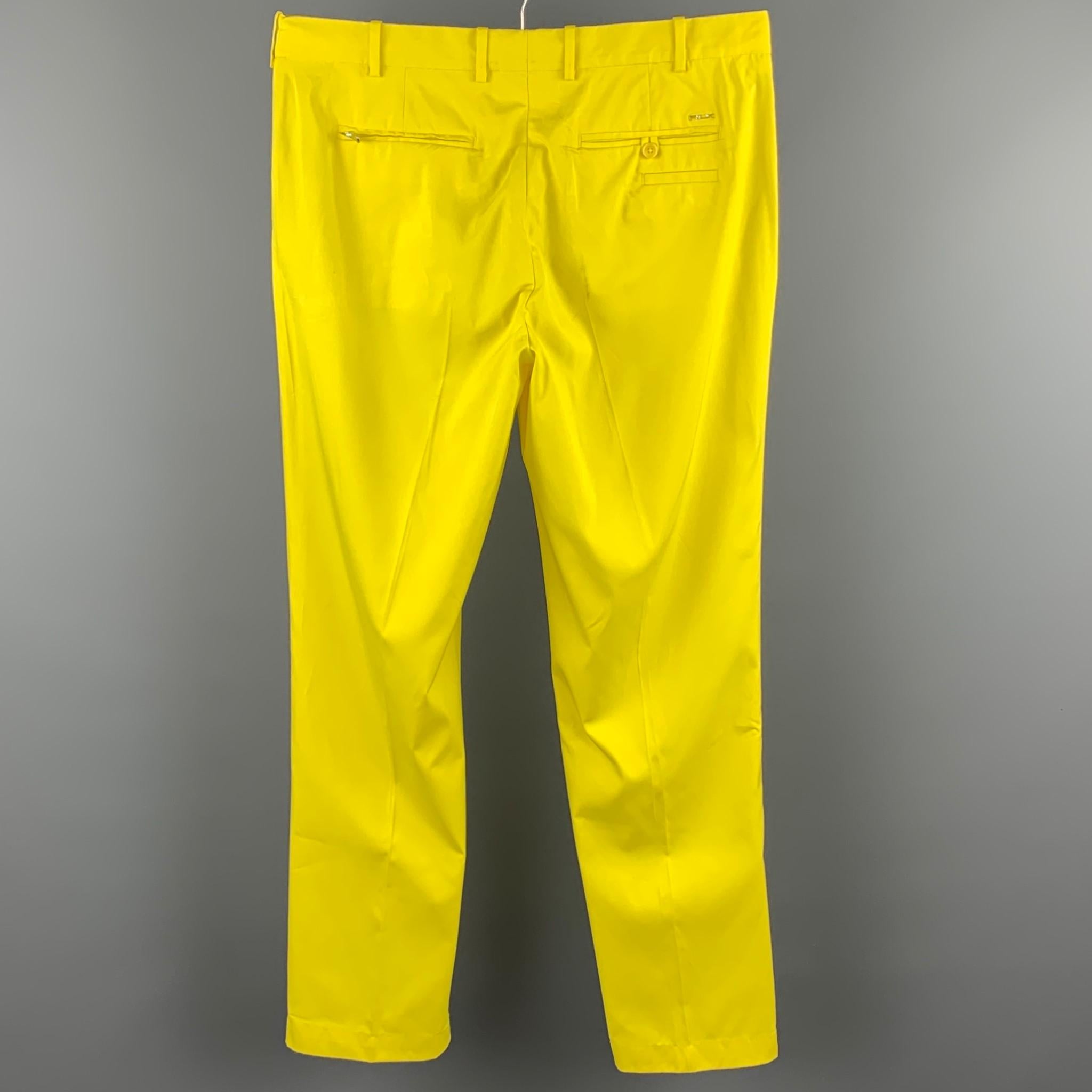 RLX by RALPH LAUREN dress pants comes in a yellow polyester featuring a straight leg, front tab, and a zip fly closure. Moderate wear.

Good Pre-Owned Condition.
Marked: 36/34

Measurements:

Waist: 36 in.
Rise: 11 in.
Inseam: 33 in. 