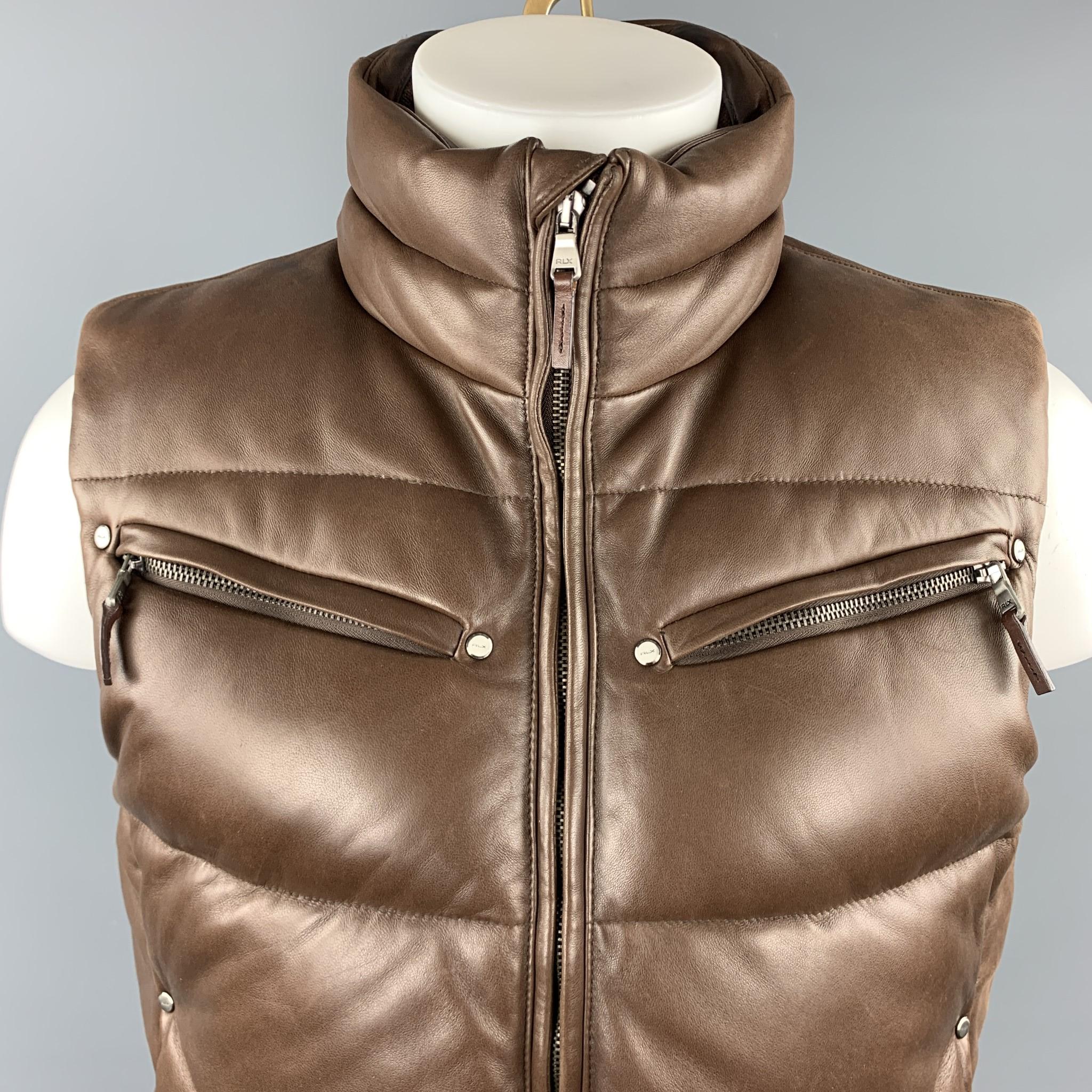 RLX by RALPH LAUREN puff vest comes in brown quilted leather with down filling, high neck, zip front, and zip pockets. Wear throughout leather and around collar. 

Very Good Pre-Owned Condition.
Marked: M
Original Retail Price:
