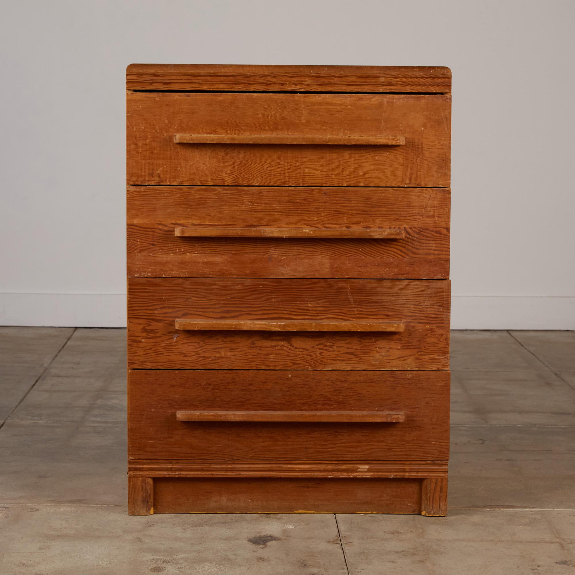 A five-drawer dresser in the style of Rudolph Schindler that features a Douglas fir wood frame with attached linear wood drawer pulls with rounded edges. The top of the dresser has a ridged detail with rounded edges while the base has a recessed