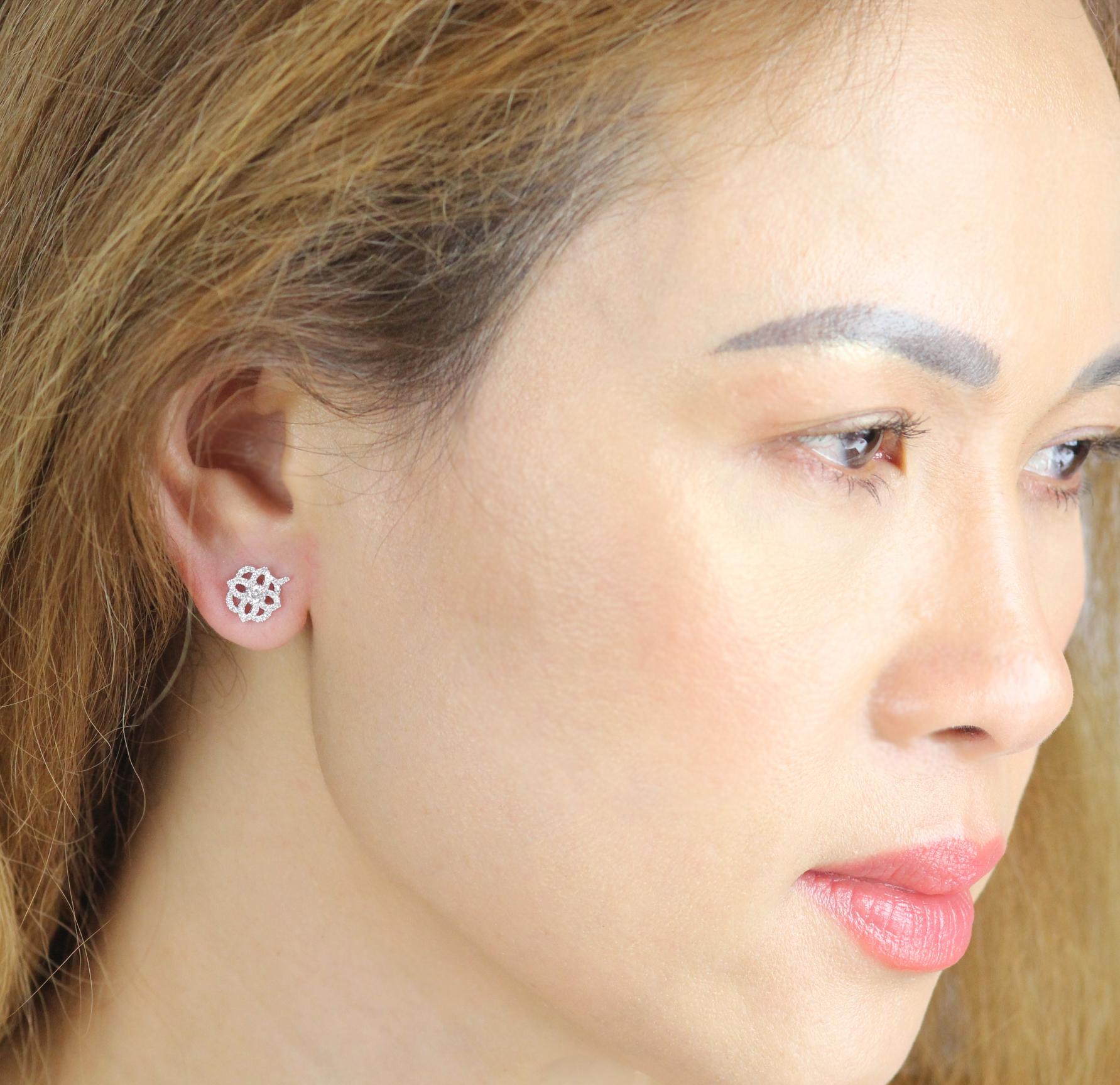 A detailed and decorative pair of contemporary white diamond earrings the double quatrefoil design of which has a hint of a Celtic rose.
 
With a total diamond weight of 0.48ct these are perfect day to evening earstuds that will become your best