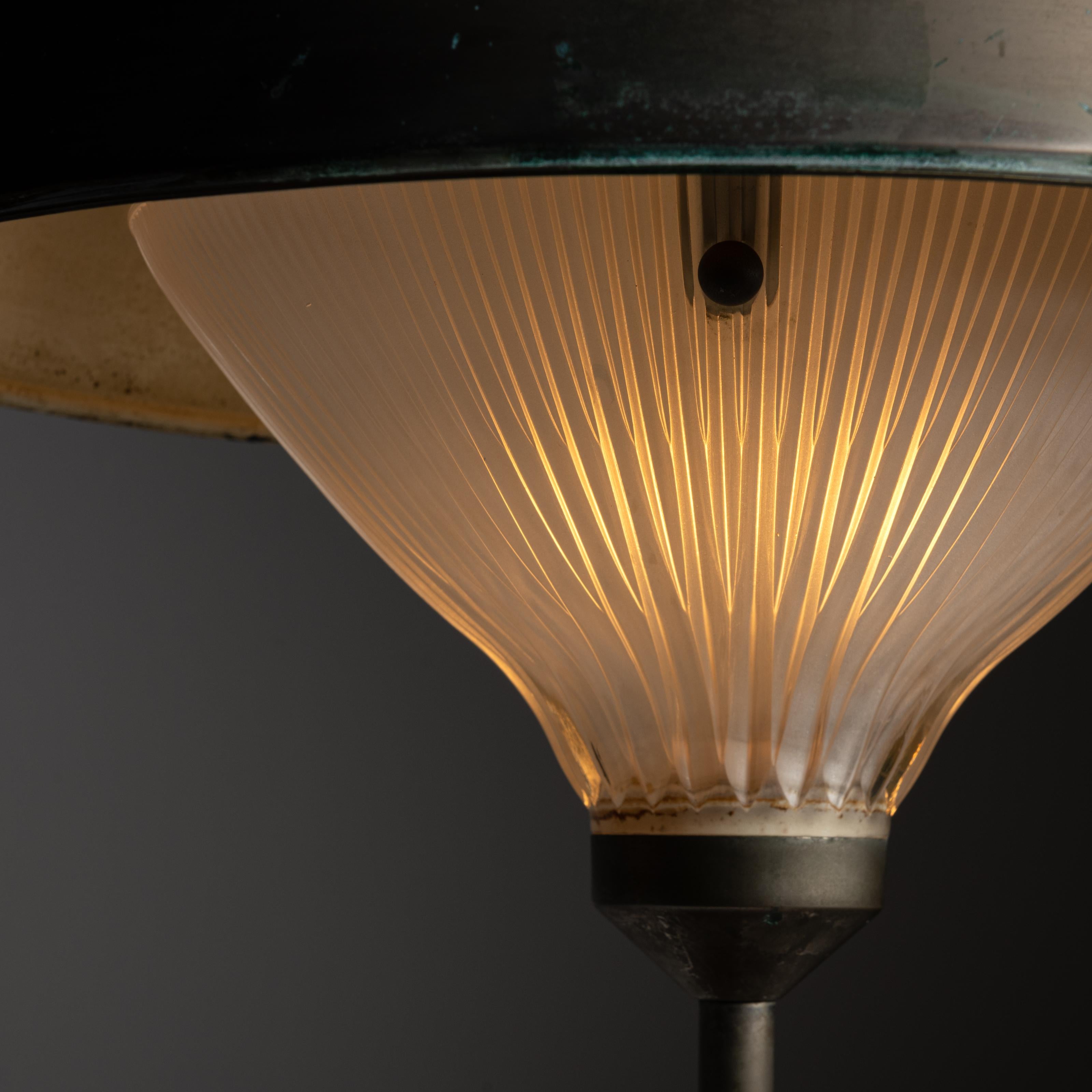 'Ro' table lamp by Studio BBPR for Artemide. Designed and manufactured in Italy, 1963. Metal umbrella shape with beveled tear drop reeded glass. The lamp features an extrusion of the beveled glass on the center top of the frame. Holds one E14 socket
