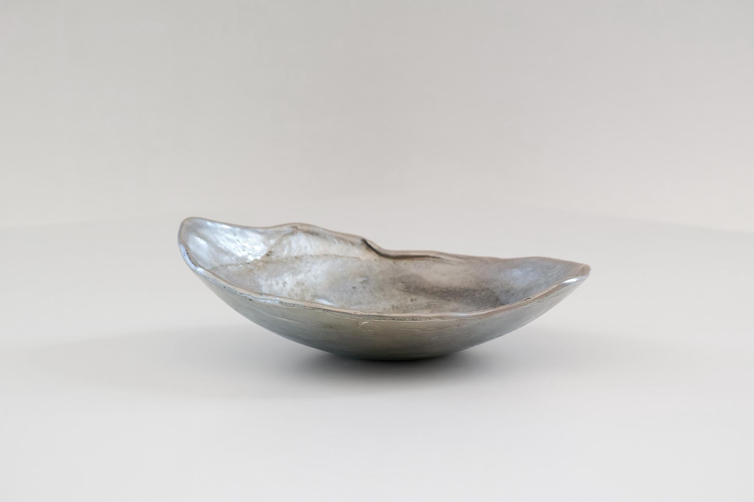 For your consideration is this rare handmade solid pewter dish by Norwegian artist, Roar Schanke, featuring a lovely organic form and surface reminiscent of an oyster or moon crater. The bottom is signed 