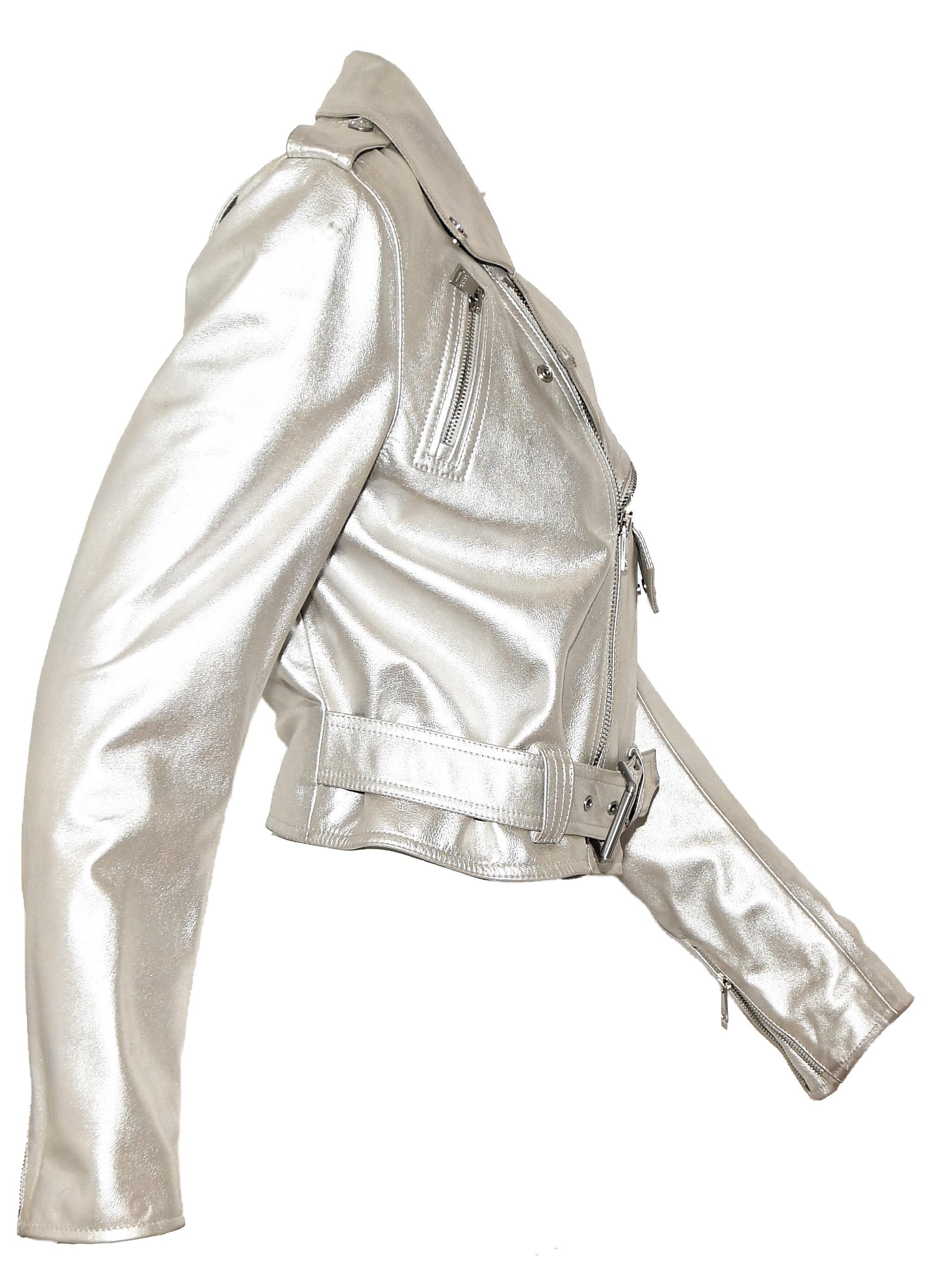 Ralph Lauren silver tone metallic motorcycle jacket contains multiple zippers throughout the jacket.   One front zipper for closure, supported with a belt, at waist.  Two asymmetric pockets each with a zip and, also, at the cuffs.  This silver