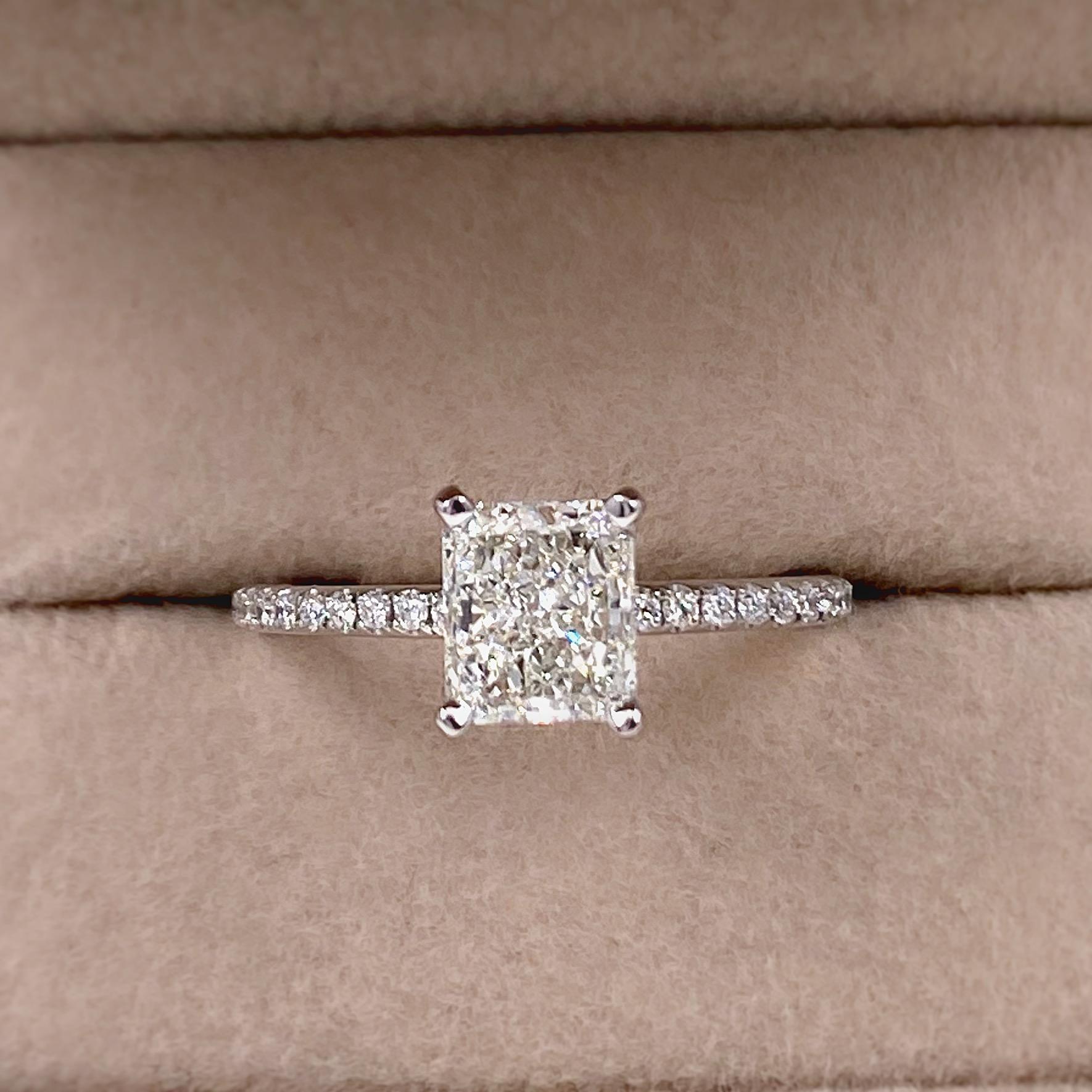 FOREVERMARK Radiant Diamond Engagement Ring
Style:  Solitaire with accents
Ref. number:  2193362
Metal:  14kt White Gold
Size:  6.75 - sizable
TCW:  1.45 tcw
Main Diamond:  Radiant Diamond
Color & Clarity:  I - VS2
Accent Diamonds:  0.25 tcw
Color &
