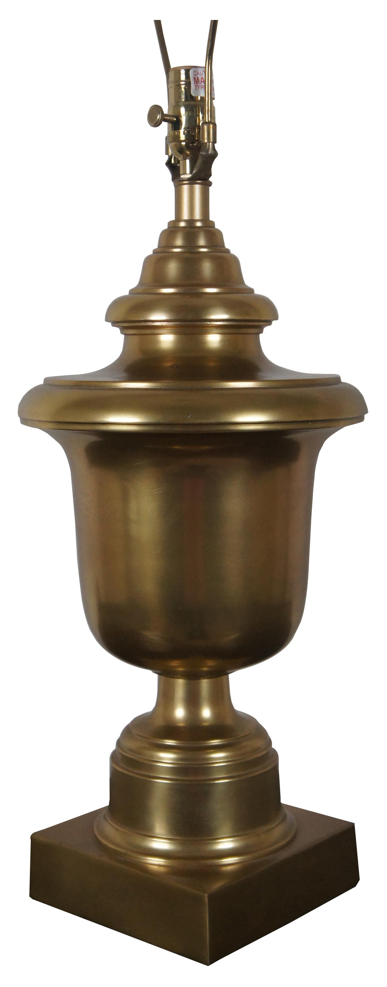 Robert Abbey Templeton trophy urn style brushed brass table lamp; no shade.

Measures: 10” x 24” / Height to Top of Finial – 32.25” (Diameter x Height).