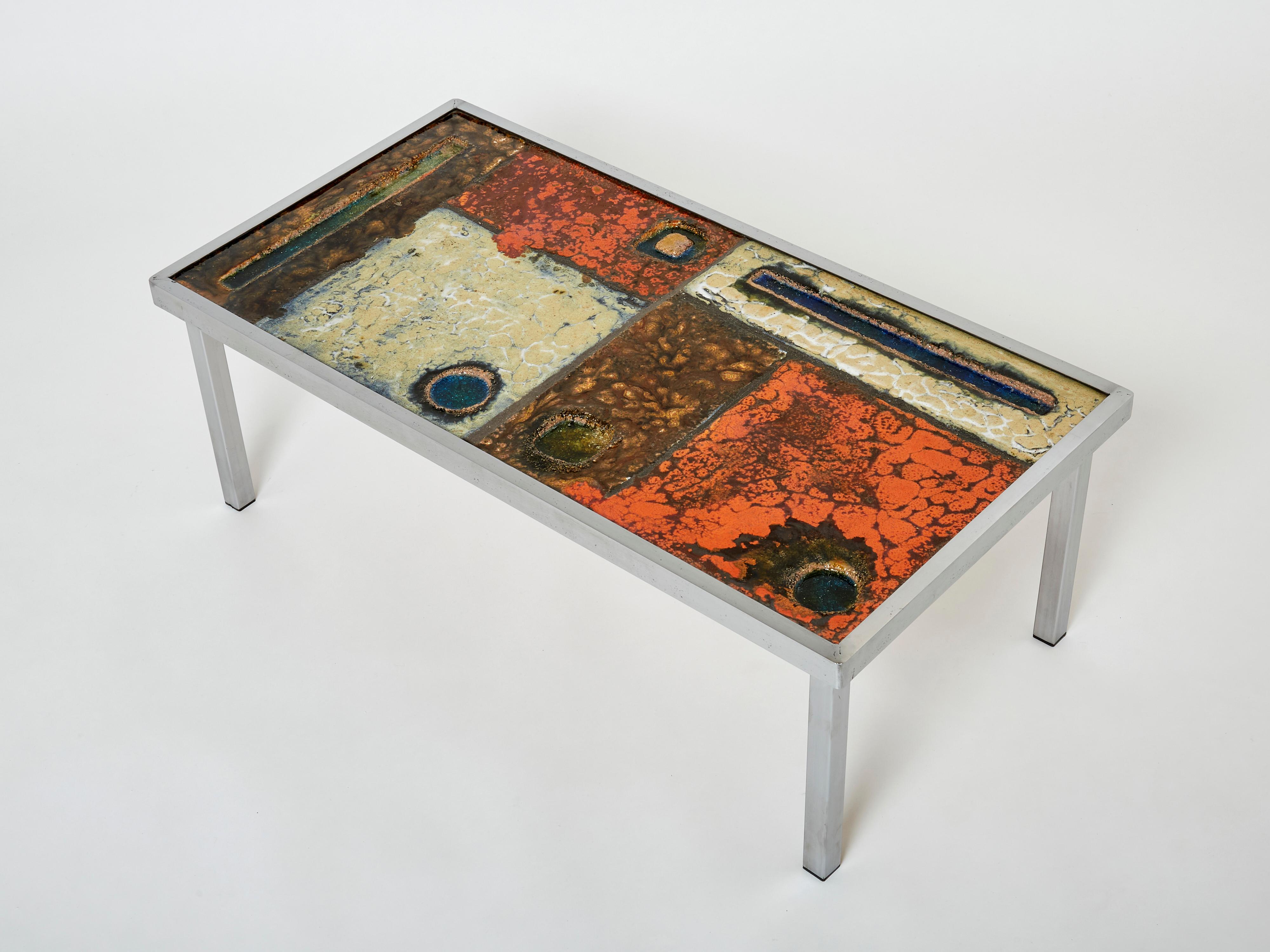 Robert and Jean Cloutier were ceramicists who viewed their work as art, with functionality as perhaps a secondary purpose. The ceramic table surface made in enamelled lava stone, with glass inclusions, explodes with warm colors. Organic-feeling