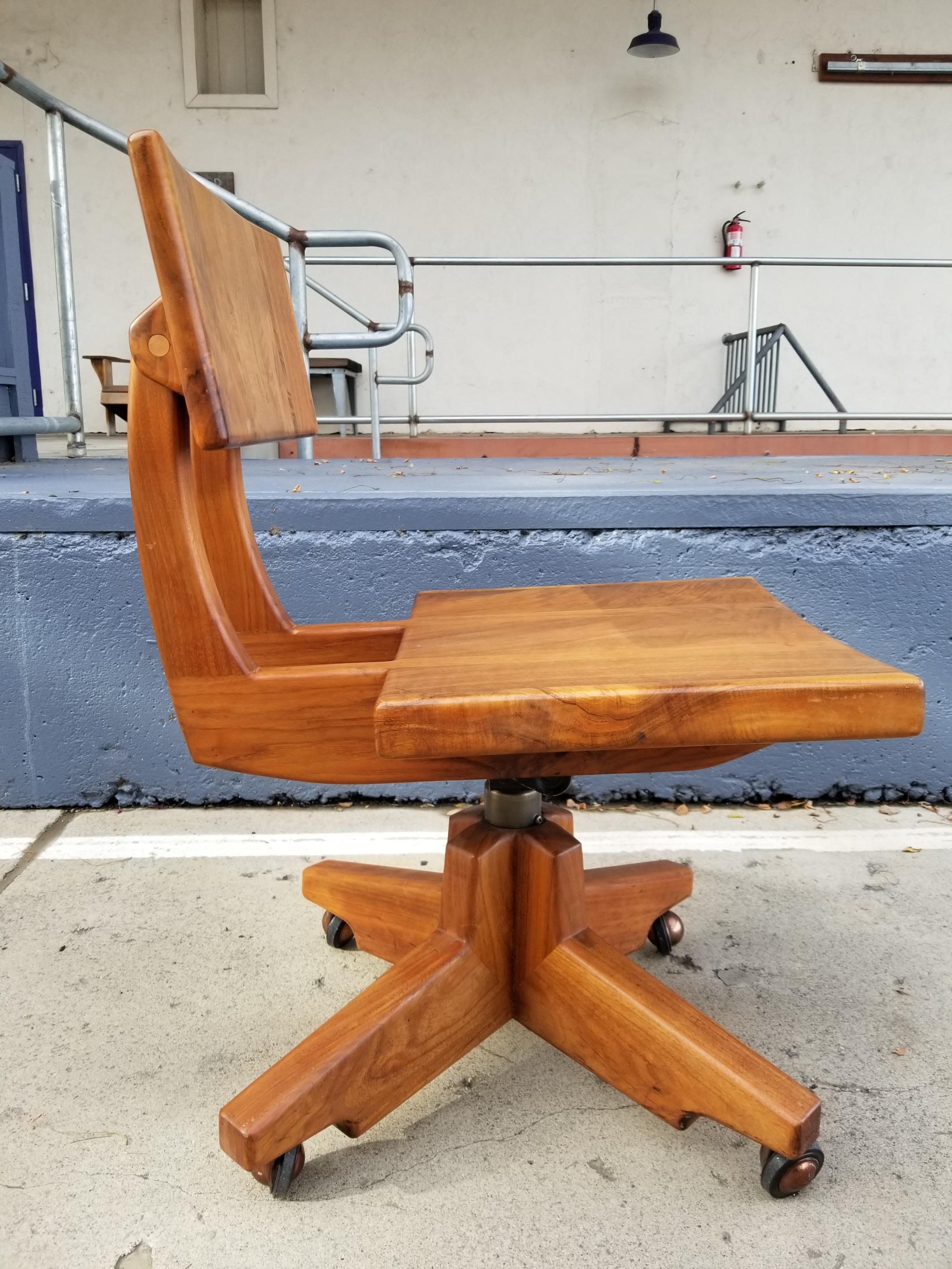 A Mid-Century Modern swivel, work or desk chair handcrafted by Robert & Joanne Herzog. Exceptional craftsmanship with all peg and mortise construction. Made of a solid, figured hardwood. Seat back rest tilts for additional comfort. Seat height is