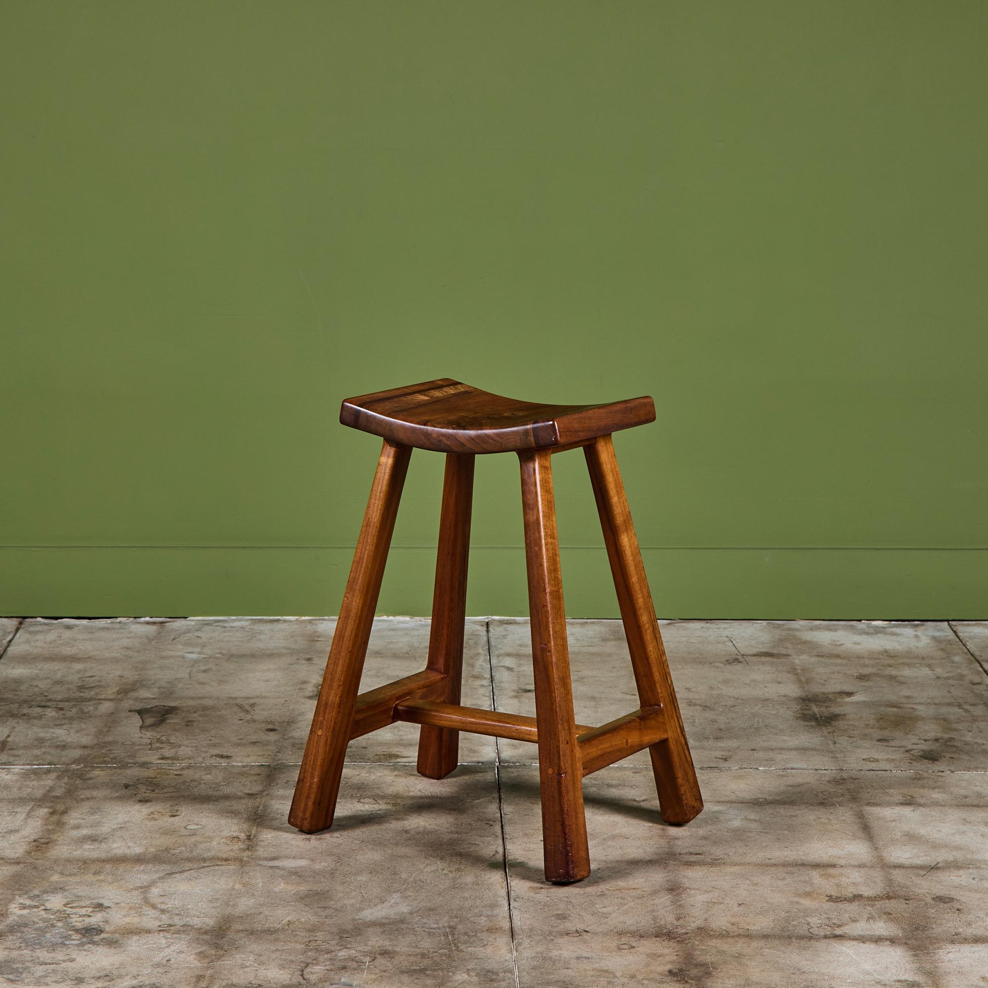 Walnut studio craft stool by California design couple Robert and Joanne Herzog c.1984. The stool features a curved rectangular seat and four sculpted legs. Underside is stamped HERZOG - 1984.

Dimensions
19