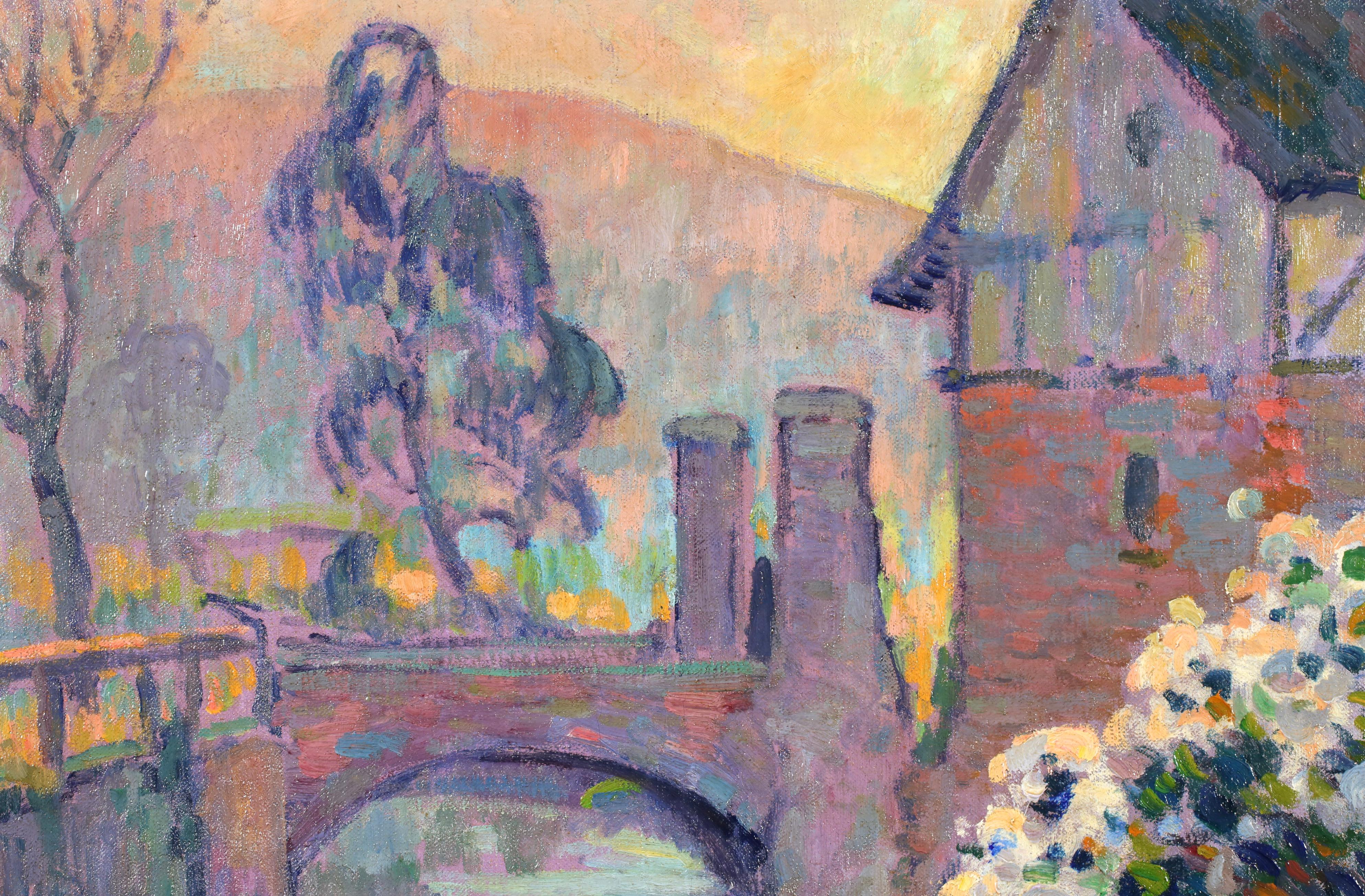 Signed fauvist oil on canvas riverscape circa 1912 by French post impressionist painter Robert Antoine Pinchon. This autumnal landscape depicts a view of a bridge over a river with a house beside it. In the foreground, flowers are overhanging the