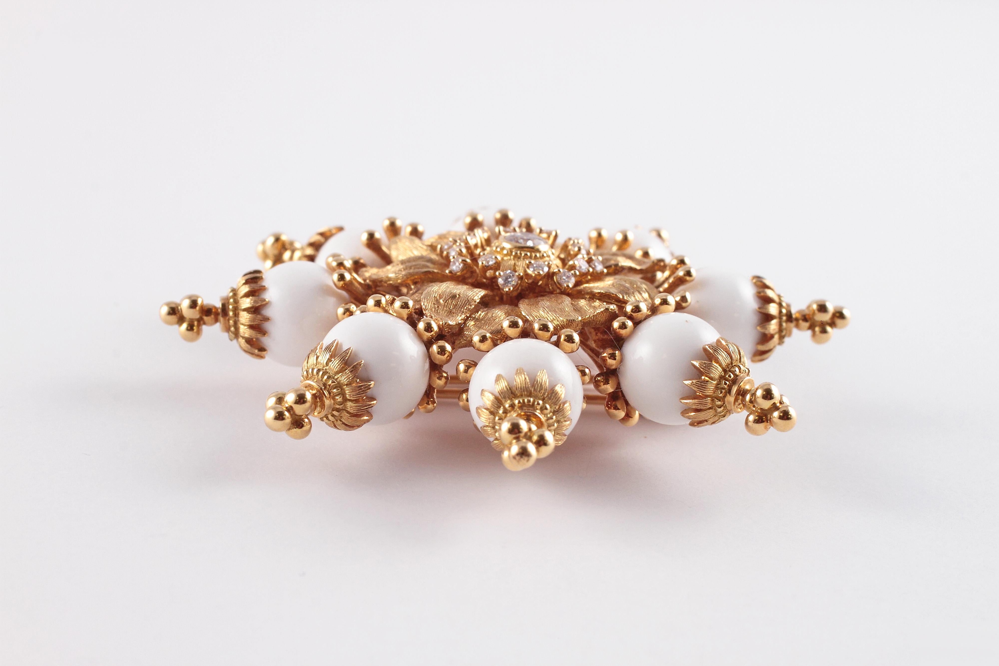 So many options with this  Robert Bielka brooch!  The main brooch is in 18 karat yellow gold and features 0.60 carats of diamonds in the center.  The beads are all interchangeable for such a diverse look and the item is secured with a double pin