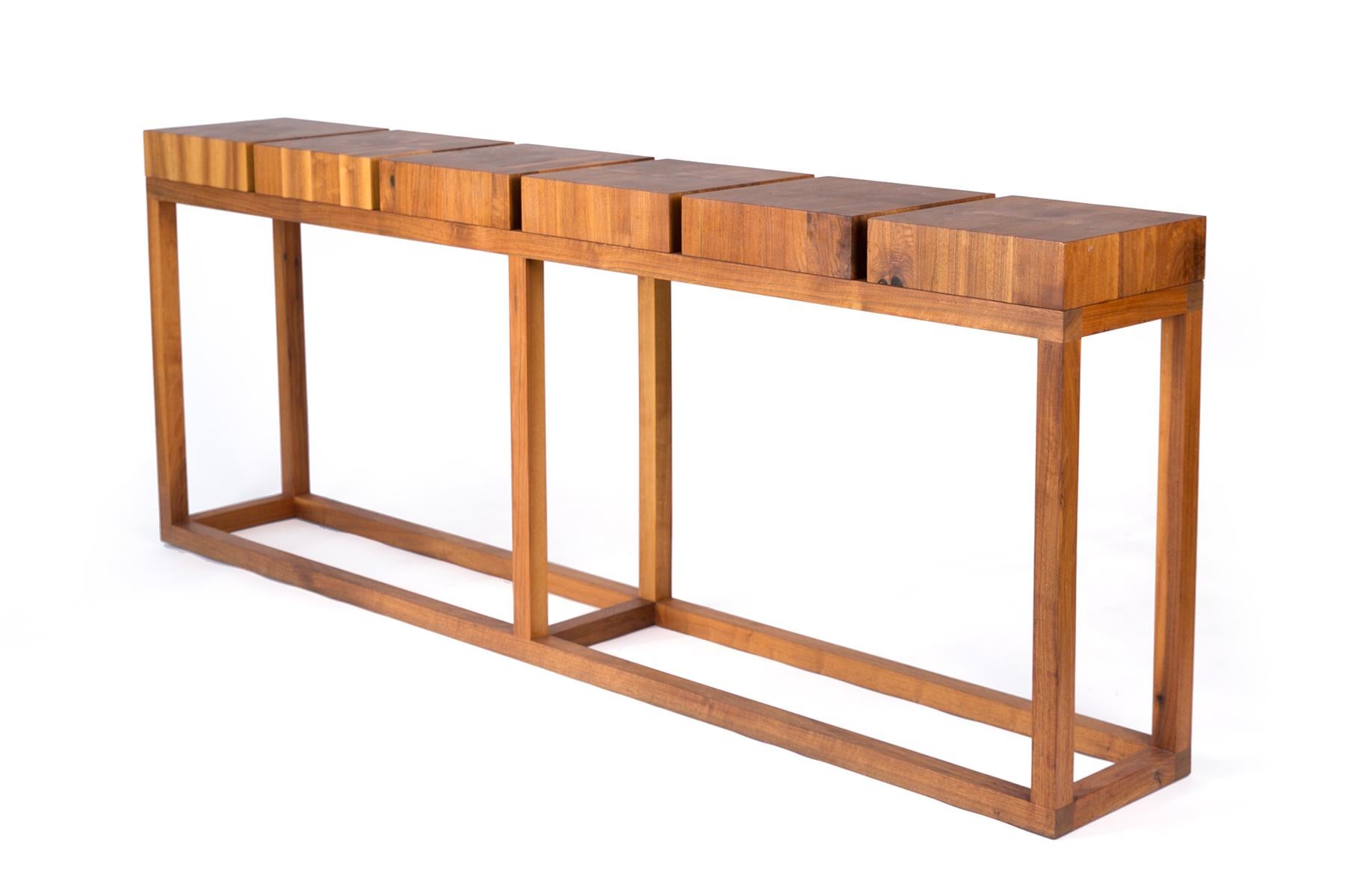 Clean modern lines matched with beautiful wood grain patterns make this distinctive solid walnut console table by Robert Bristow for Ralph Pucci a striking and versatile piece in any home. Console is signed by Bristow on the underside.