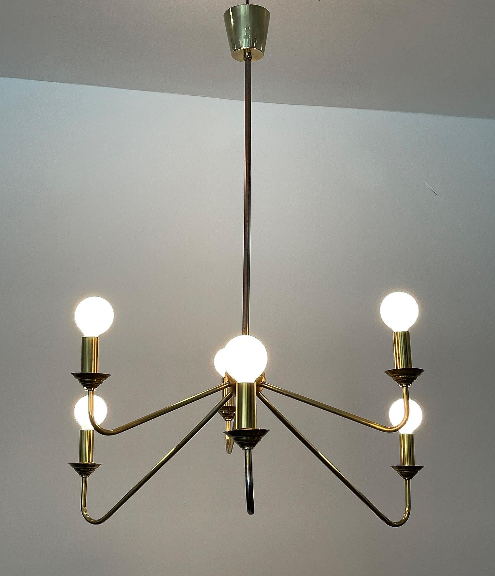 Brass chandelier, Robert Caillat, circa 1955.
Brass chandelier from a set of ten with six-light. Fully rewired to be used in US.
Candelabra sockets with brass hardware.
We got ten similar chandeliers from this hotel, different colors and degrees