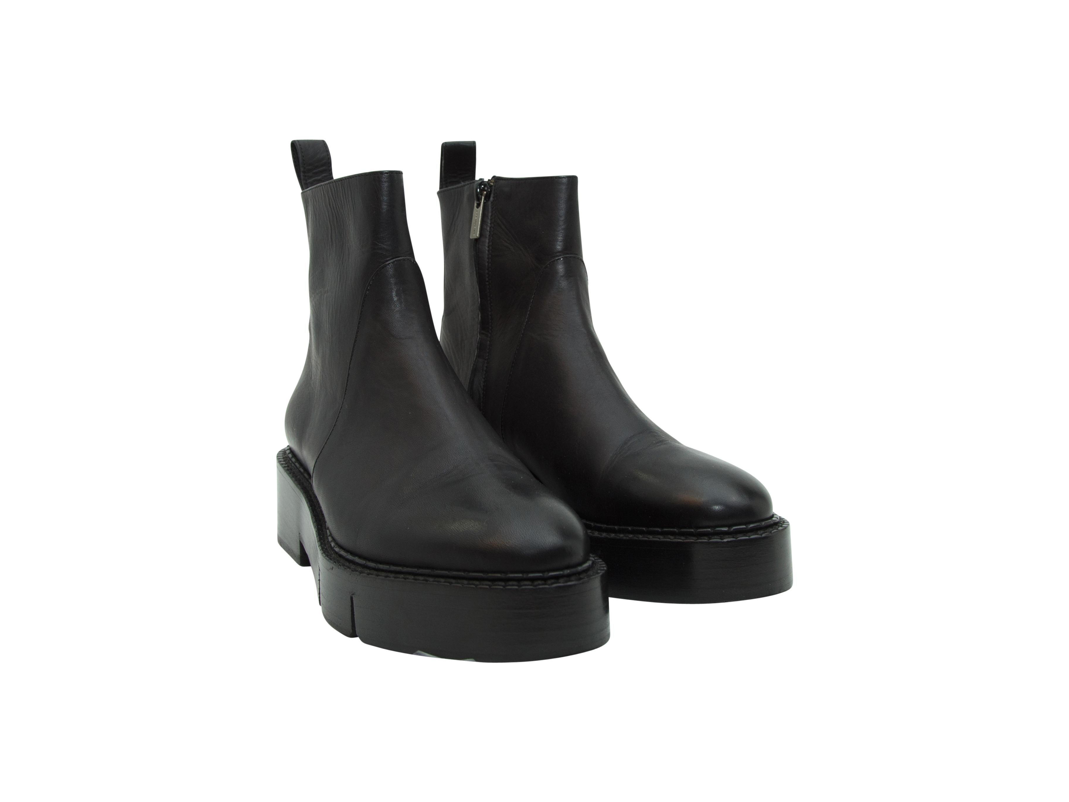 Product details:  Black leather ankle boots by Robert Clergerie.  Inner zip closure.  Round toe.  Stacked heel.  2