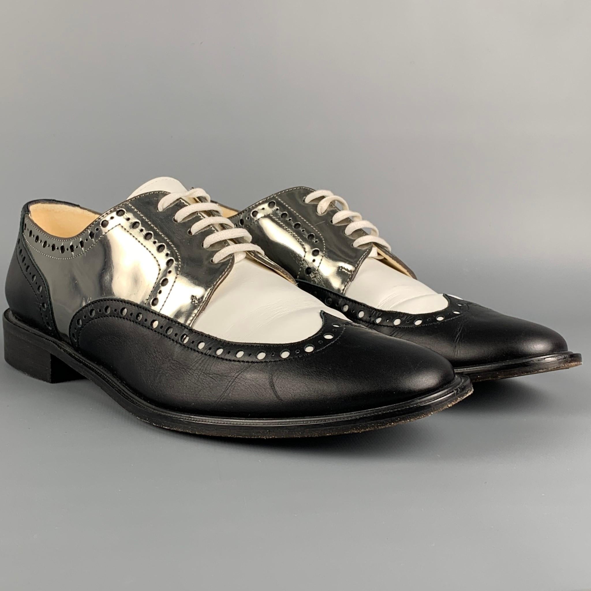 ROBERT CLERGERIE shoes comes in a black & white color block leather featuring a spectator style, metallic silver tone trim, and a lace up closure. Made in France. 

Very Good Pre-Owned Condition.
Marked: 40.5 B 01 1602 14

Outsole: 11.5 in. x 4 in. 