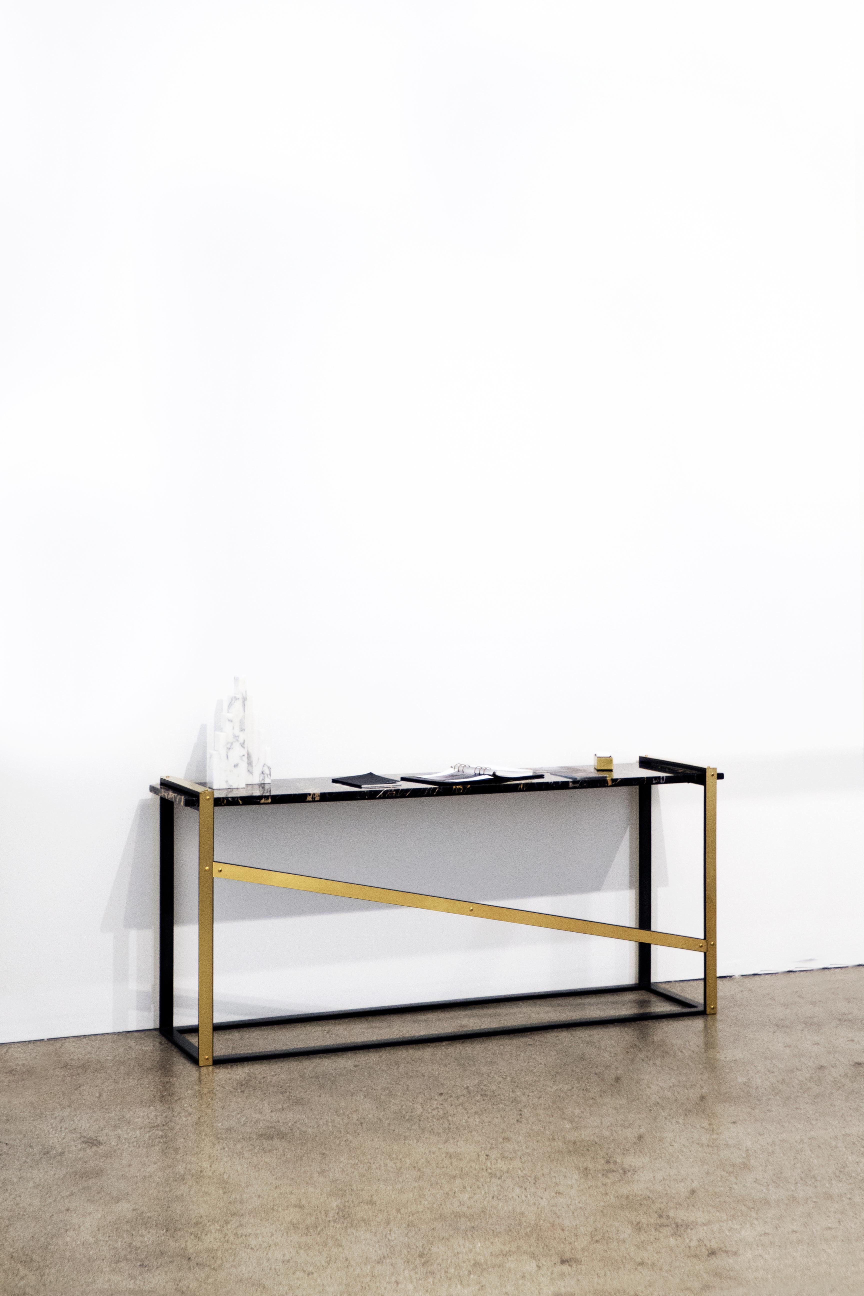 The (wh)ORE HAüS STUDIOS Robert console table is made of blackened steel, marble and brass accents. This table is made to order and can, therefore, be customized. As pictured; Blackened steel, unlacquered brushed brass lashings, and Saint Laurent