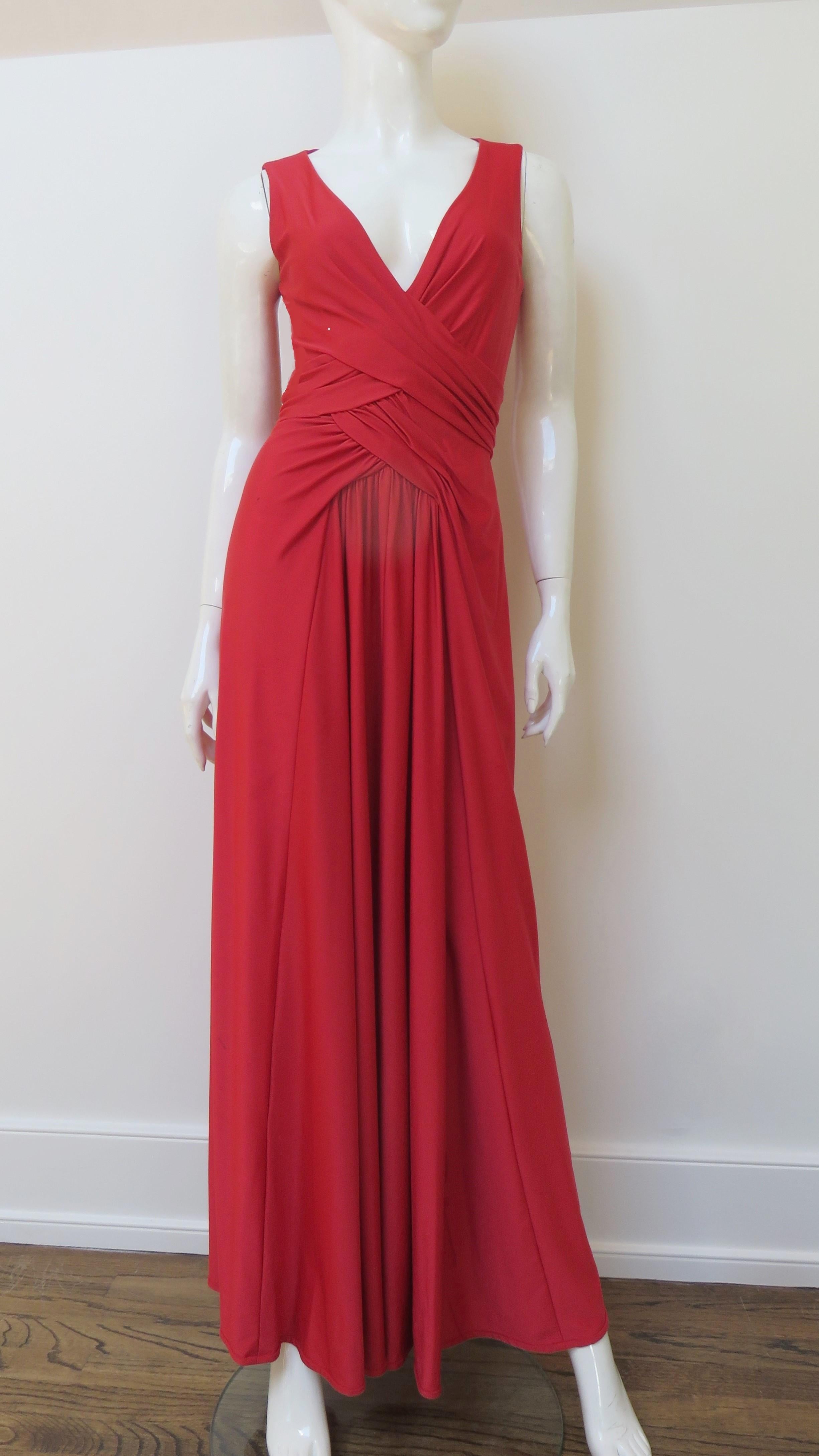 A fabulous red jersey maxi dress from Robert David Morton.  It is sleeveless with a deep V neckline and panels of ruching crossing at the midriff and waist.  It is unlined and has a center back zipper.
Fits sizes Small, Medium.  Marked US size