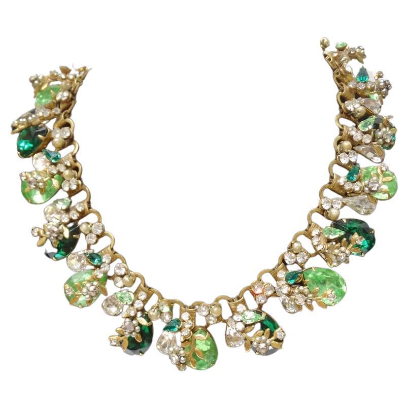 Calling all green lovers! This incredible 1980s Robert Parvre synthetic diamond necklace is compromised of the most beautiful palette of green tones alongside intricate flower motifs to make for a glamorous statement necklace inspired by beauties of