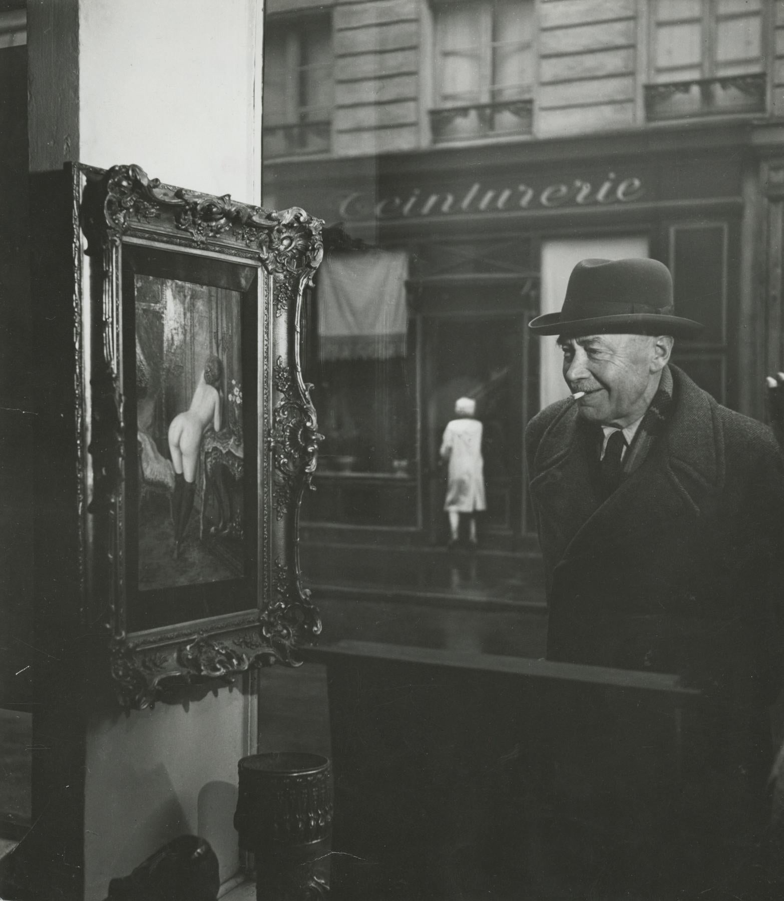 Robert Doisneau Black and White Photograph - Man Looking at Painting of a Nude in Paris Shop Window, 1948