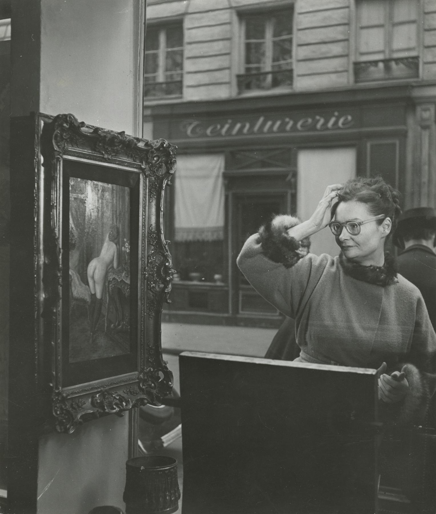 Robert Doisneau Black and White Photograph - Woman Looking at Painting of a Nude in Paris Antique Shop Window, 1948