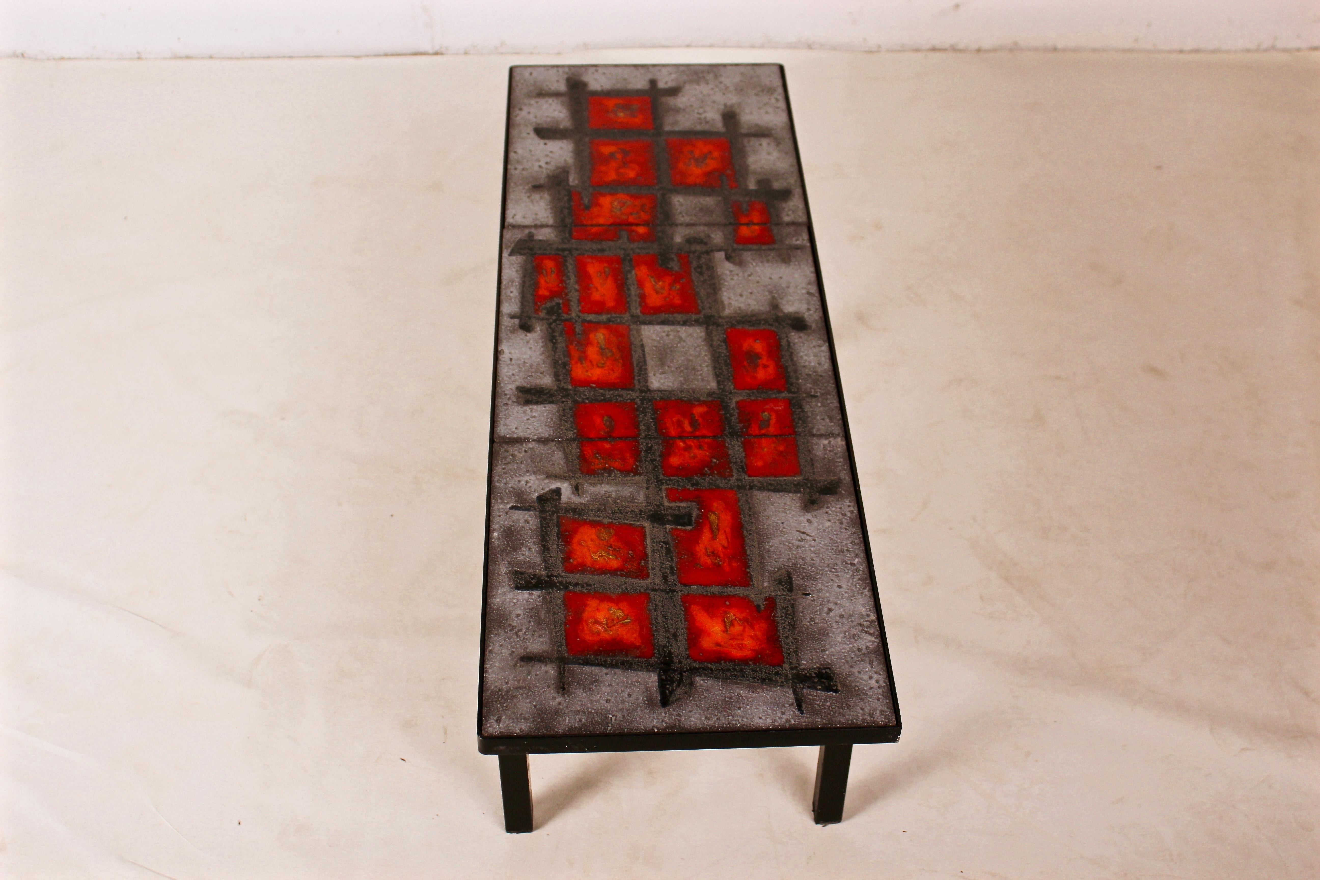 Robert and Jean Cloutier were twins, artists and ceramicists, born in 1930, France
This lava stone coffee table enameled by Robert and Jean Cloutier is made of a top, which is in three pieces enameled with a geometric pattern with the famous red