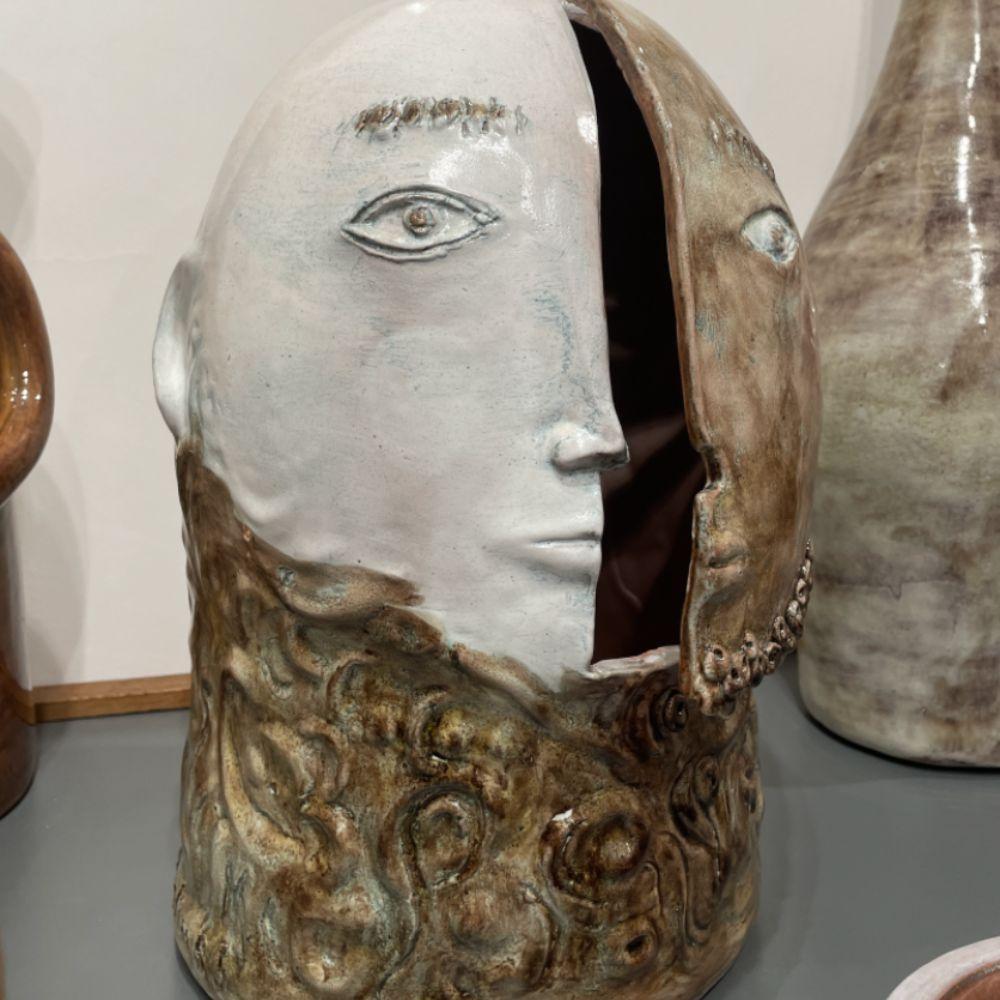 Glazed ceramic 
signed
the face opens and closes to give way to an inner space 