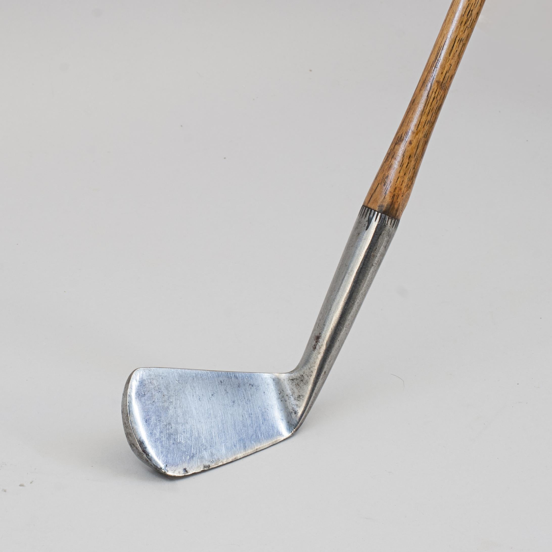 Forgan & Son Golf Club, Smooth Face Mashie.
This early Forgan & Son hickory shafted mashie has a smooth face, hickory shaft and sheep skin grip. This is a fine example of a smooth face club which also has good strong nicking around the hosel. The
