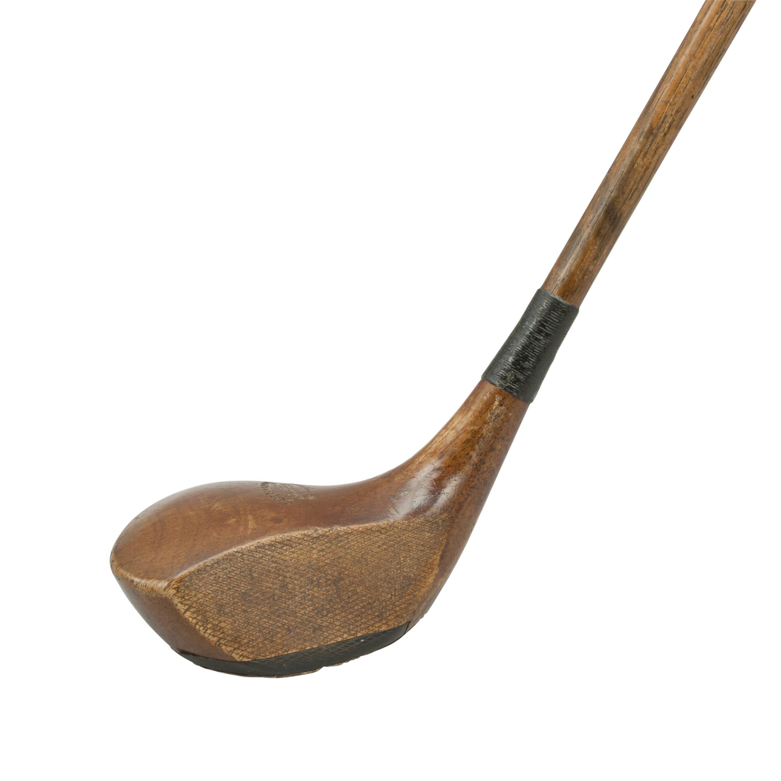 Robert Forgan Brassie Golf Club.
A good persimmon wood 'Scotia' branded hickory shafted brassie or spoon by Robert Forgan & Son of St Andrews. The club head and shaft marked with Forgan's details the crown of the club head also stamped 'Scotia'.