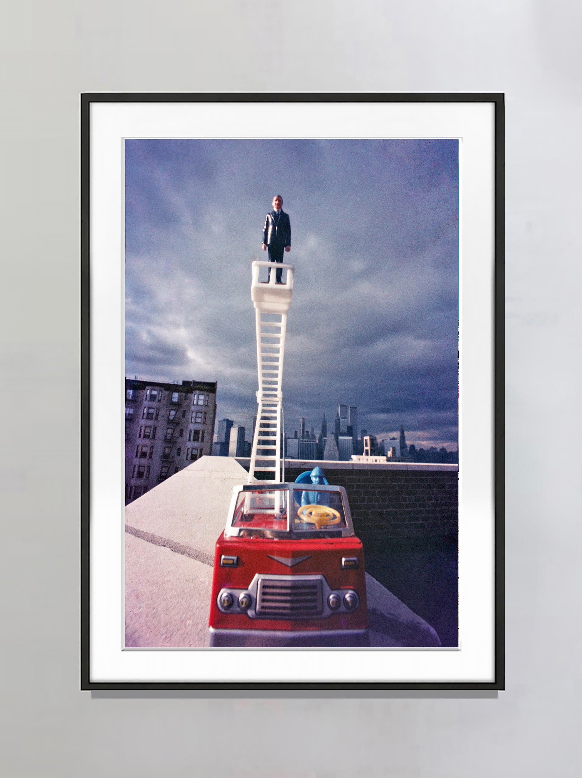 Business Man Rises Above the Manhattan Skyline - Staged Photography - Gray Landscape Photograph by Robert Funk