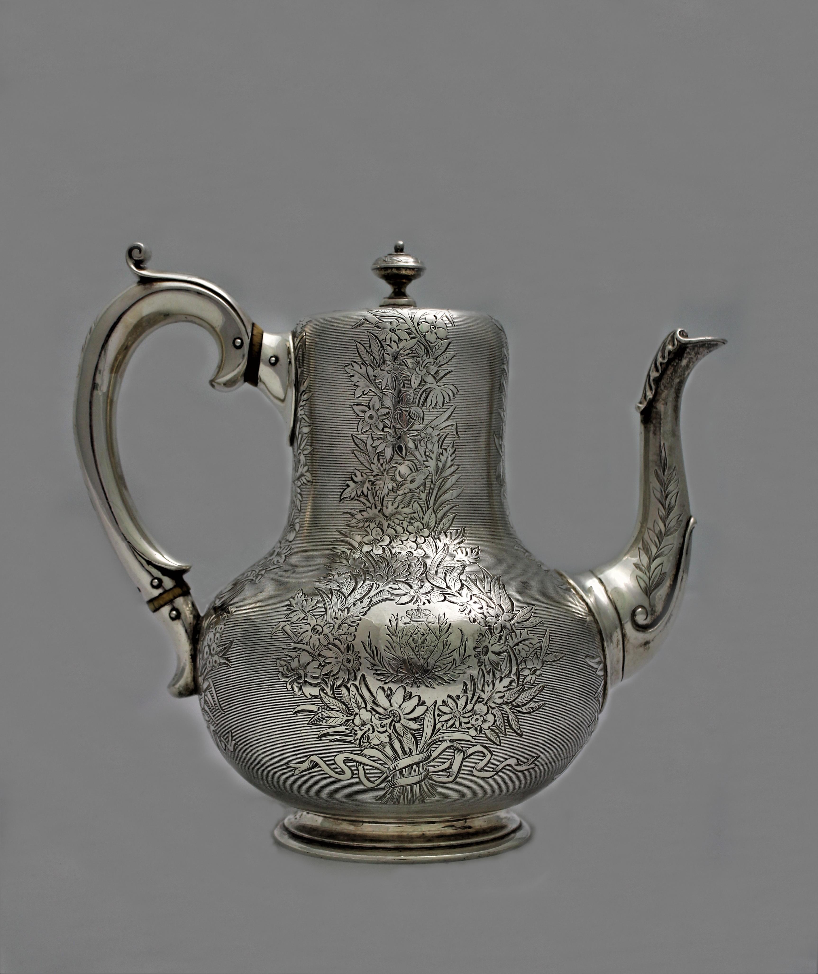 Magnificent engraved sterling silver teapot realized by Robert Garrard II in 1867, London.

Garrard was the official Crown jeweller for Queen Victoria of England and realized many masterpieces in that period.

Realized on commission for the