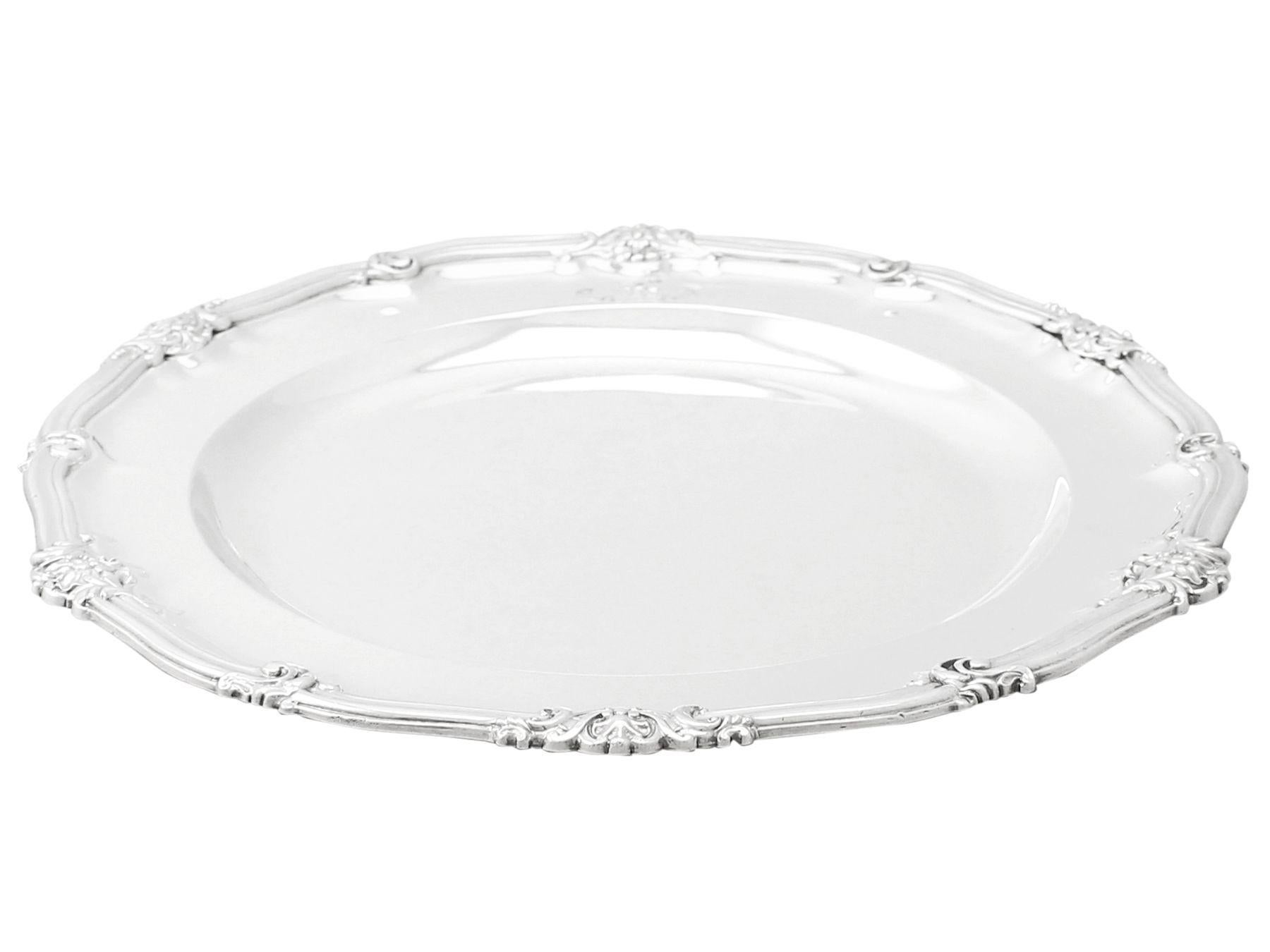 An exceptional, fine and impressive antique Victorian English sterling silver plate made by Robert Garrard II; an addition to our dining silverware collection.

This exceptional Victorian sterling silver plate has a plain circular shaped form with a
