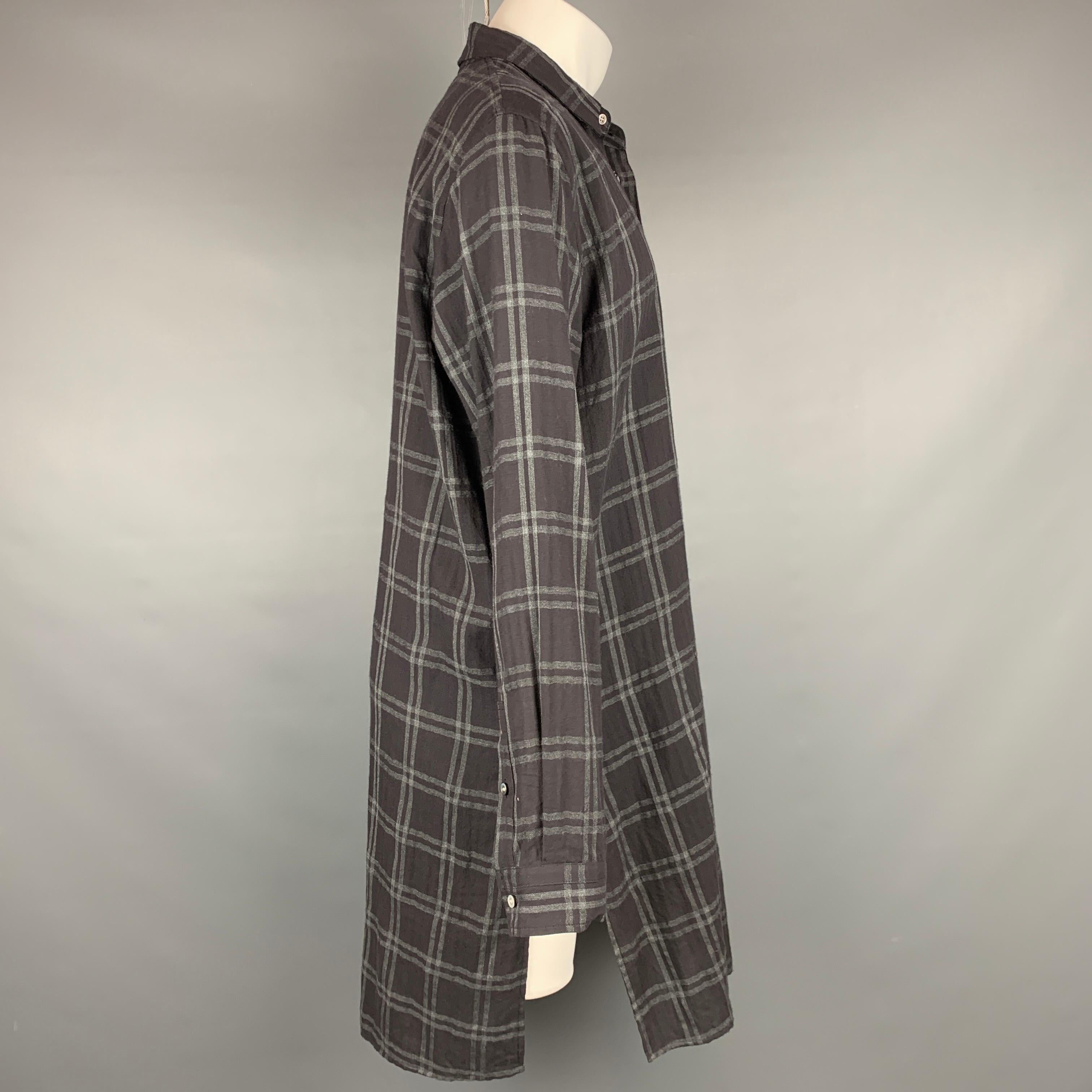ROBERT GELLER long sleeve shirt comes in a charcoal & grey plaid cotton featuring a button up style, patch pocket, and a spread collar. Made in Japan.

Very Good Pre-Owned Condition.
Marked: 52

Measurements:

Shoulder: 19.5 in.
Chest: 50