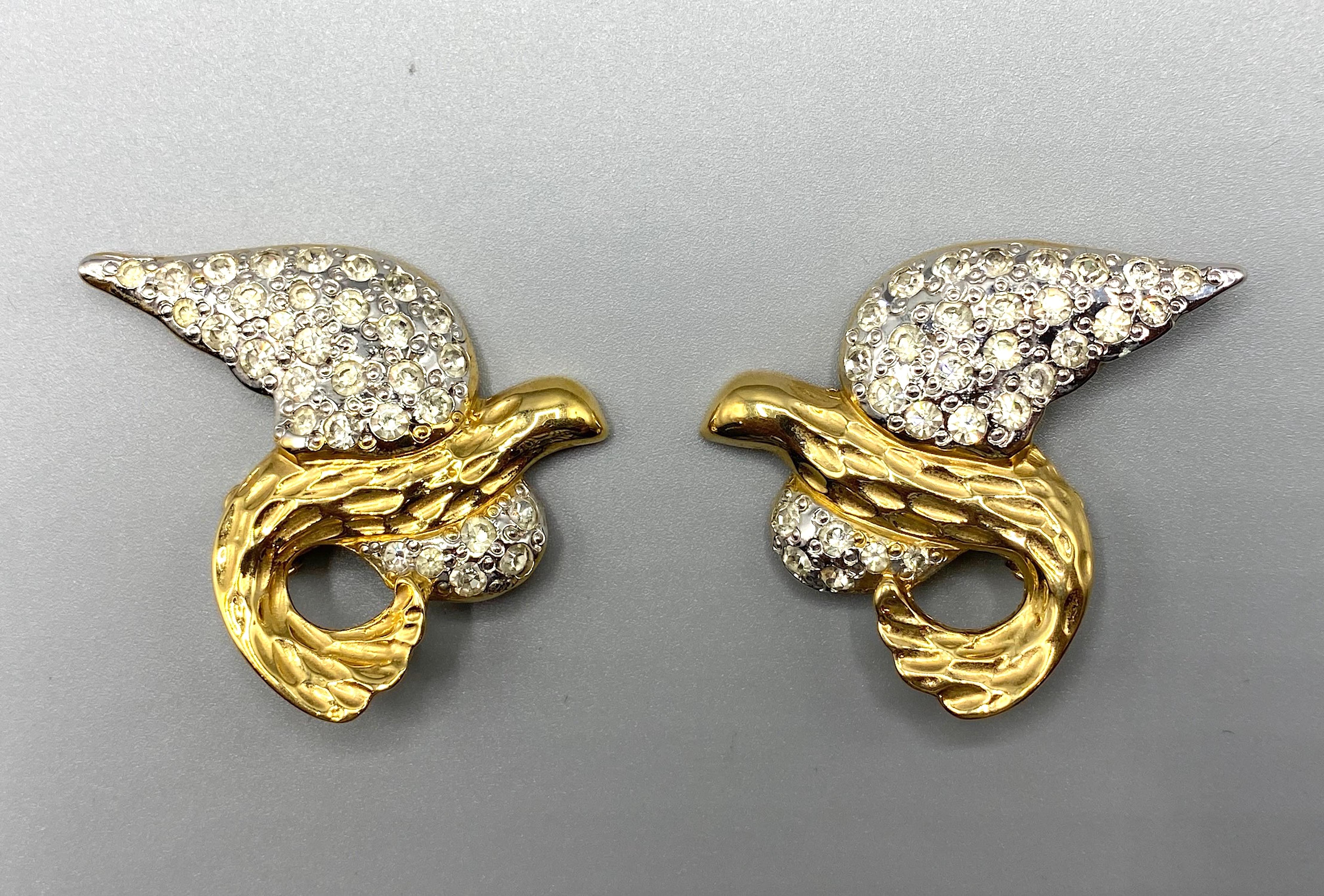 A unique 1980s pair of Yves Saint Laurent abstract bird in flight earrings designed by Robert Goosens. The wings are rhodium plated and set with rhinestones. The body is in gold plate. Goosens designed couture  jewelry for Chanel, YSL, Balenciaga,