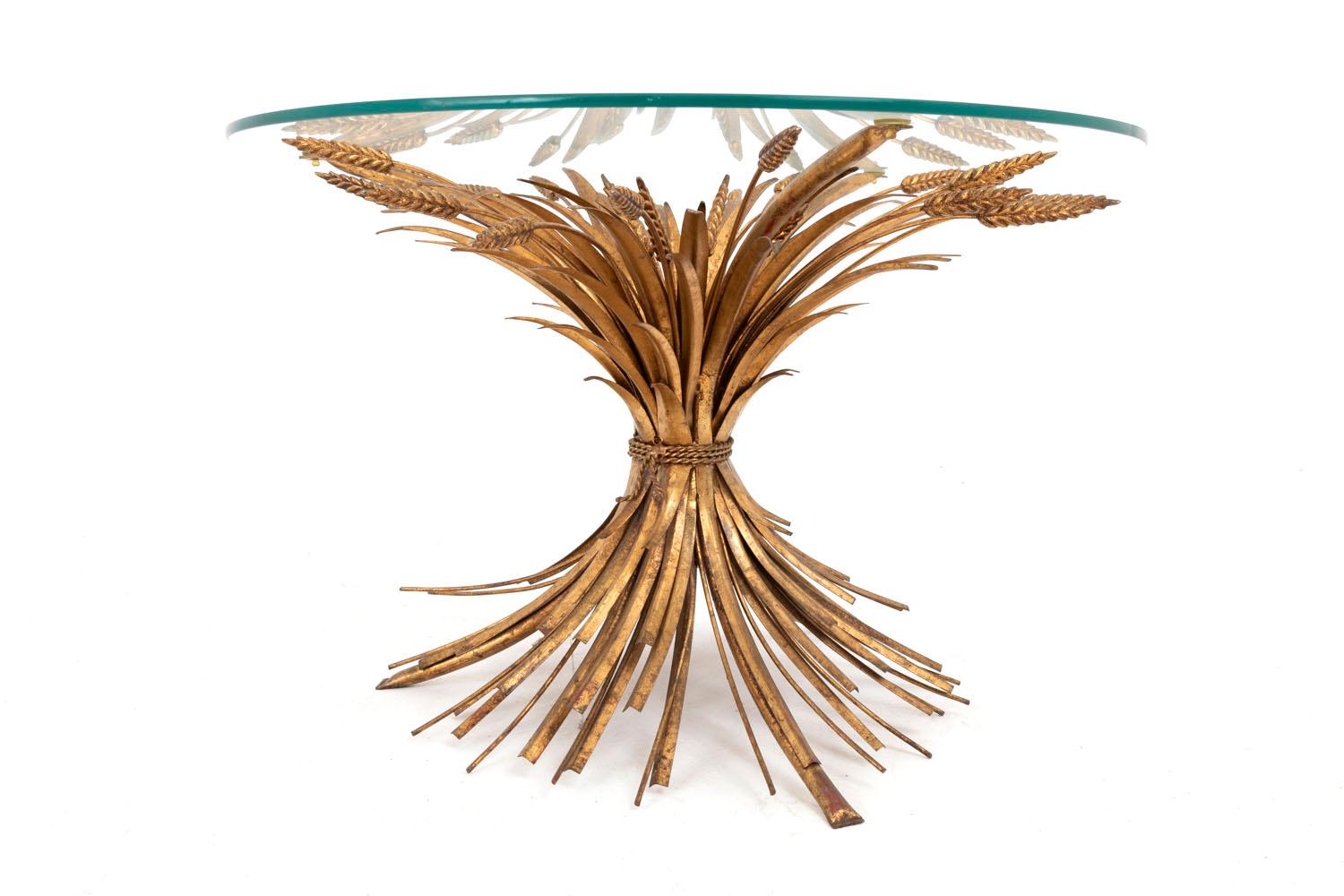Robert Goossens for Coco Chanel, in the style of. 

Gilt metal coffee table representing a wheatears sheaf held by a twisted ribbon and supporting a round transparent glass tray. Glass tray touches the sheaf on tree different places. Work from the