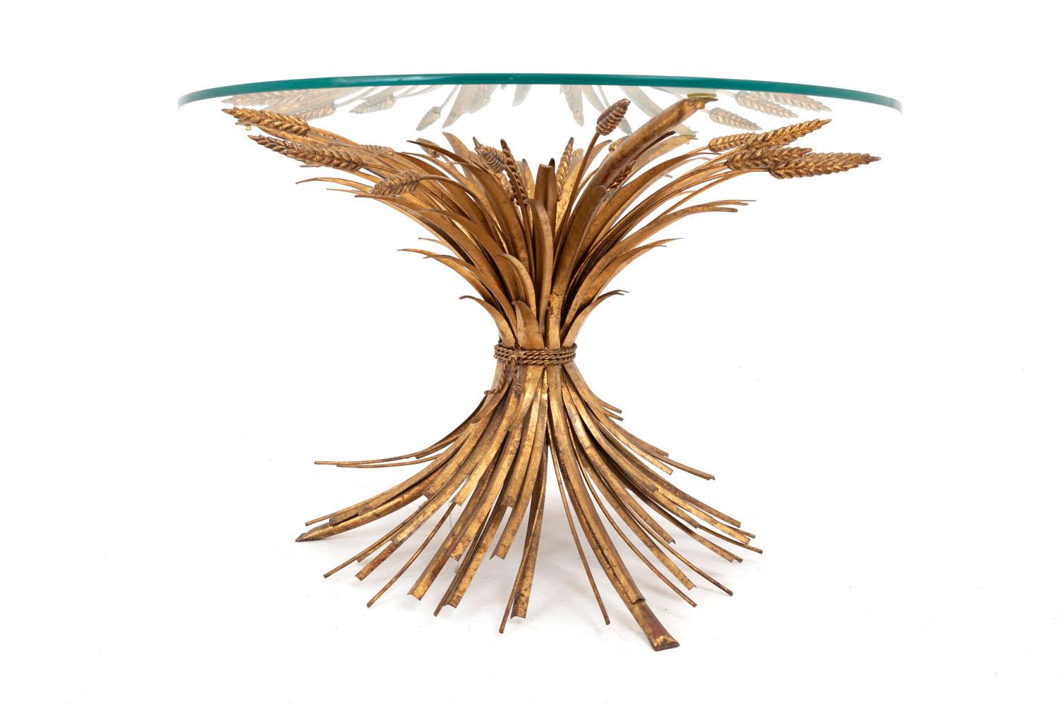 Robert Goossens for Coco Chanel, in the style of.

Gilt metal coffee table representing a wheatears sheaf held by a twisted ribbon and supporting a round transparent glass tray.
Glass tray touches the sheaf on tree different places.

Work from