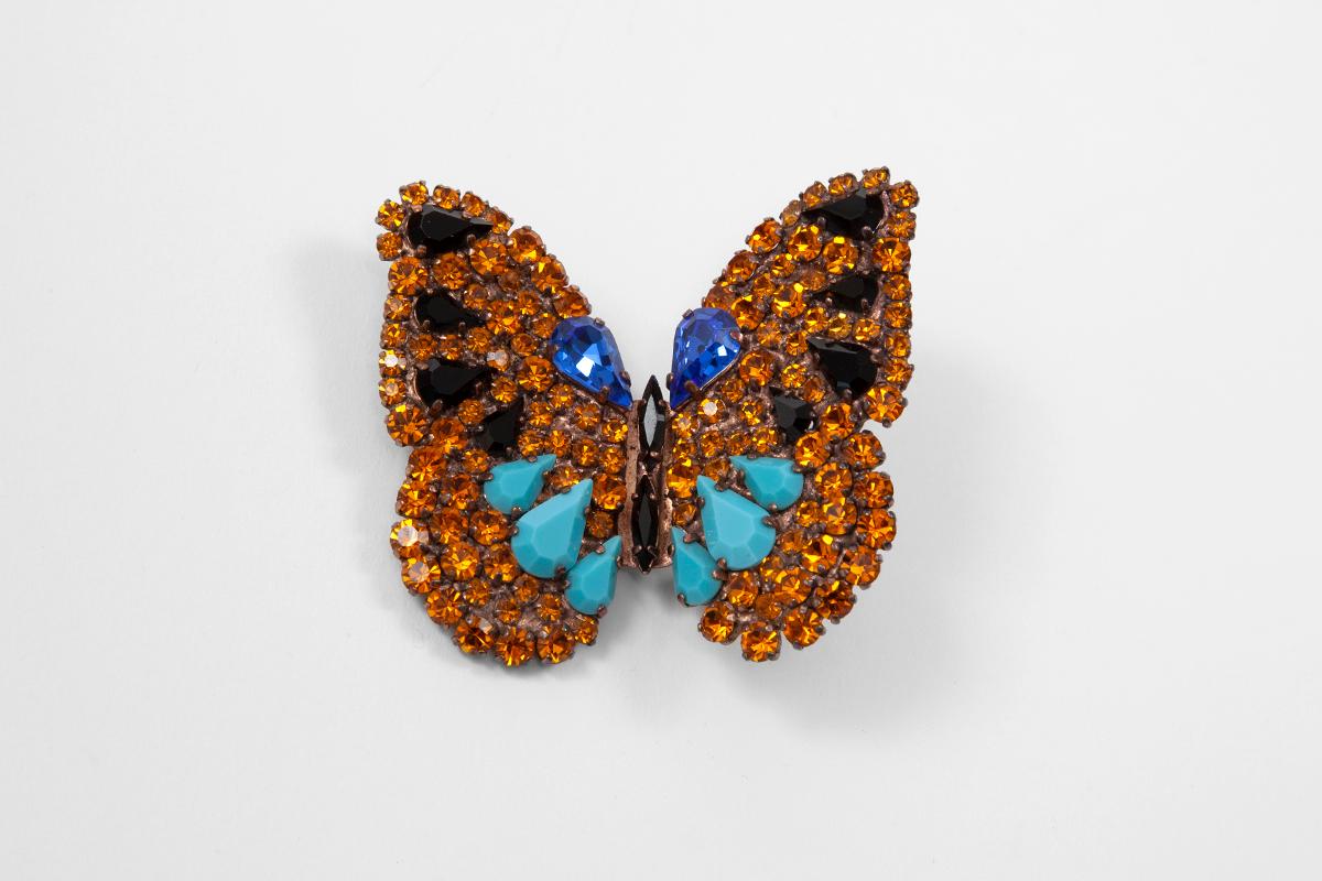 Butterflies were everlasting favorite in the design of Yves Saint Laurent. This circa 1980 Goossens for YSL brooch is made from gold-tone brass encrusted with sparkling faceted crystals of various shapes, colors and sizes. Pin it to anything from