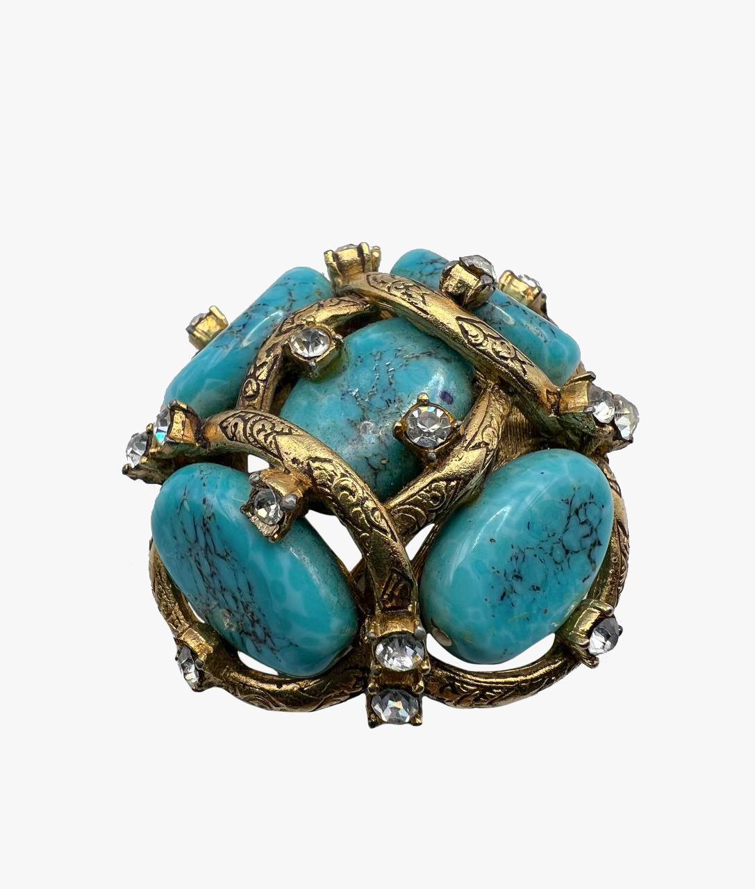 Stunning brooch with turquoise cluster, made by Robert Goossens  in 1961.

Handmade pate de verre beads made to simulate turquoise matrix set in a gilded bronze web scattered with pastes.

Dimensions –  4.8 x 4.8 cm,

Condition – very