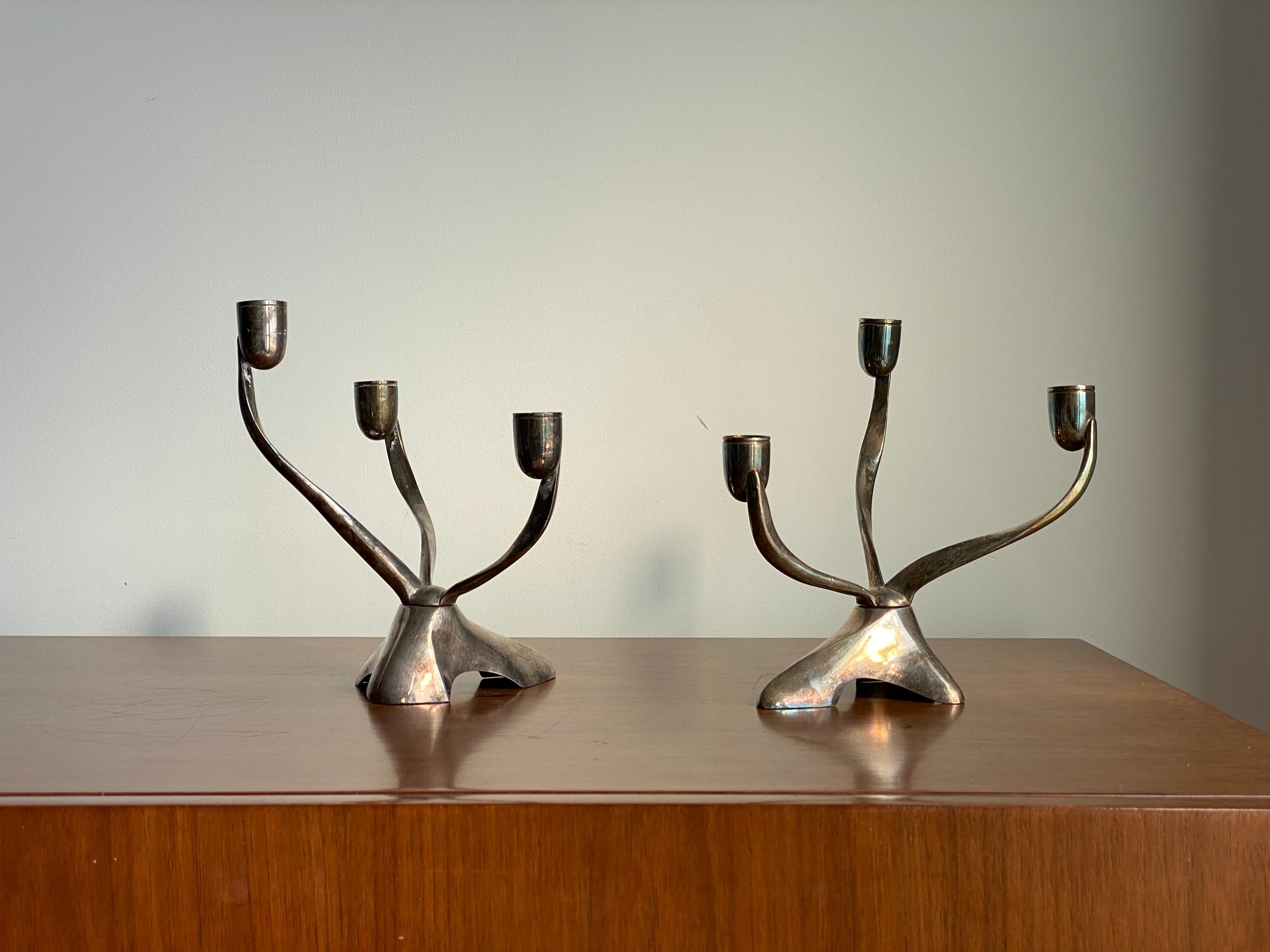 A pair of organic and sculptural candelabras. Designed by Robert H. Ramp for Reed & Barton in the 1950s. Adjustable in silver plate. Stamped with makers mark.

Other designers of the period include Buckminster Fuller, Isamu Noguchi, Paul Frankl,